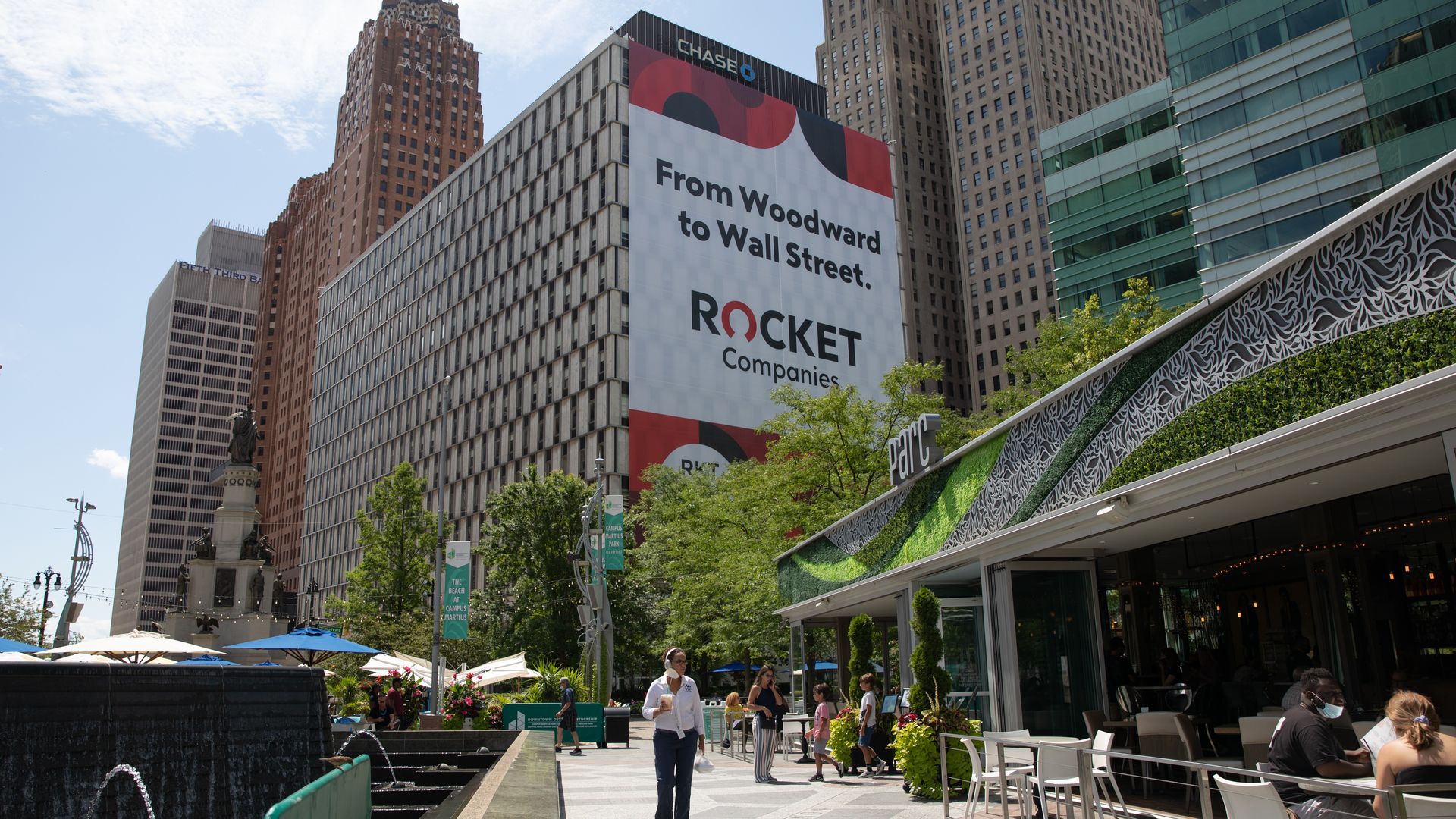 A huge billboard ad for Rocket is shown behind Campus Martius Park. 