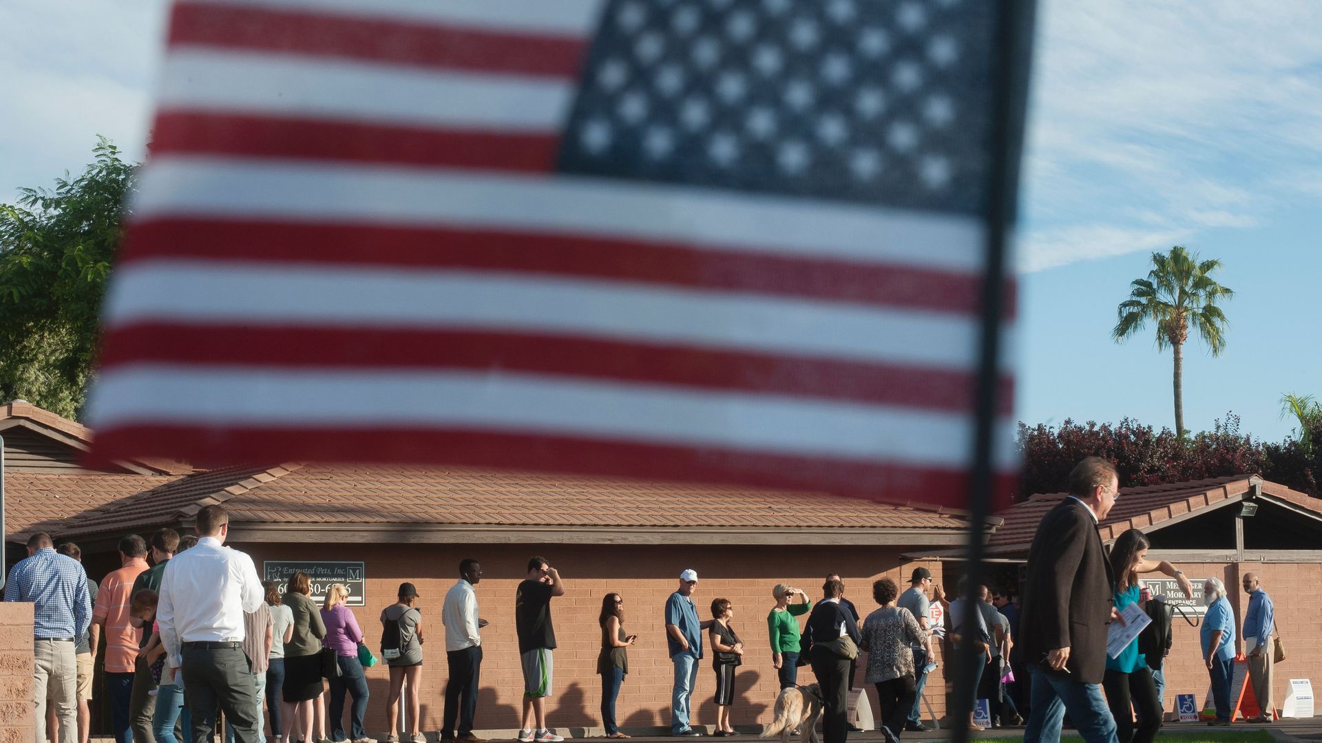 Voters wait in line in front of a polling station to cast their ballots in the 2016 presidential election