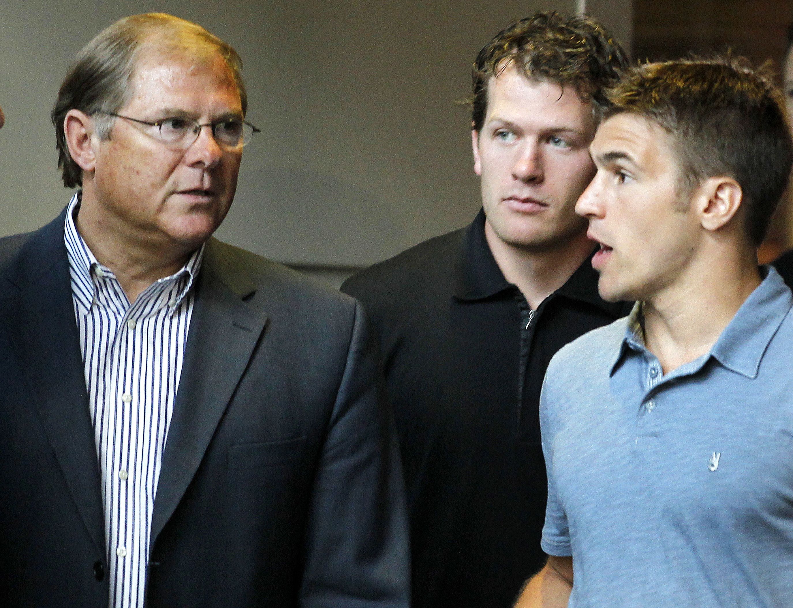 Craig Leipold, Ryan Suter and Zach Parise stand next to each other in 2012 