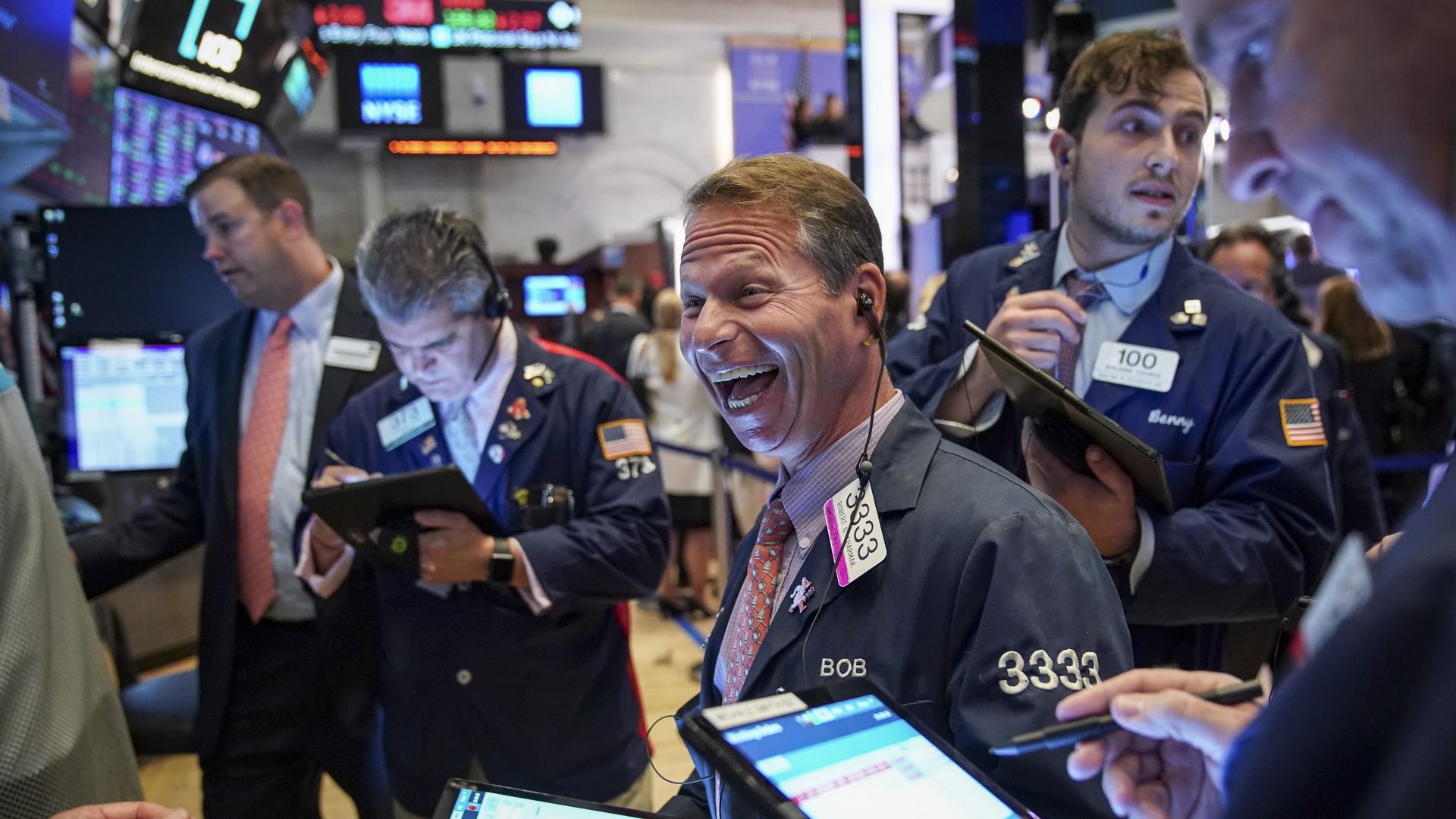 Traders look at screens on the floor of the New York Stock Exchange.