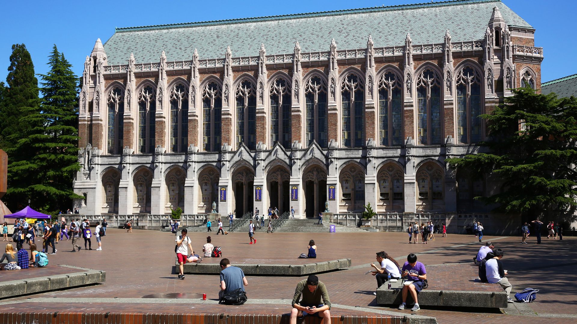 Students study on the steps of the Suzzallo Library at the University of Washington in Seattle.
