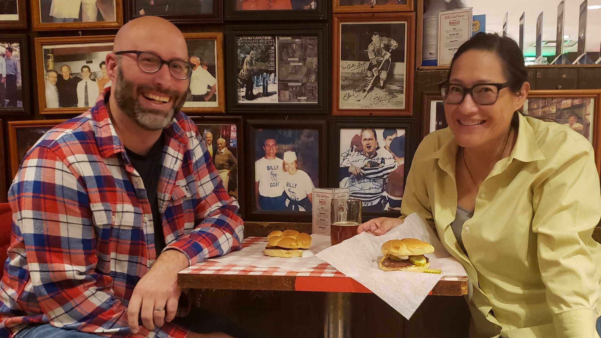 Photo of two people eating at a restaurant.