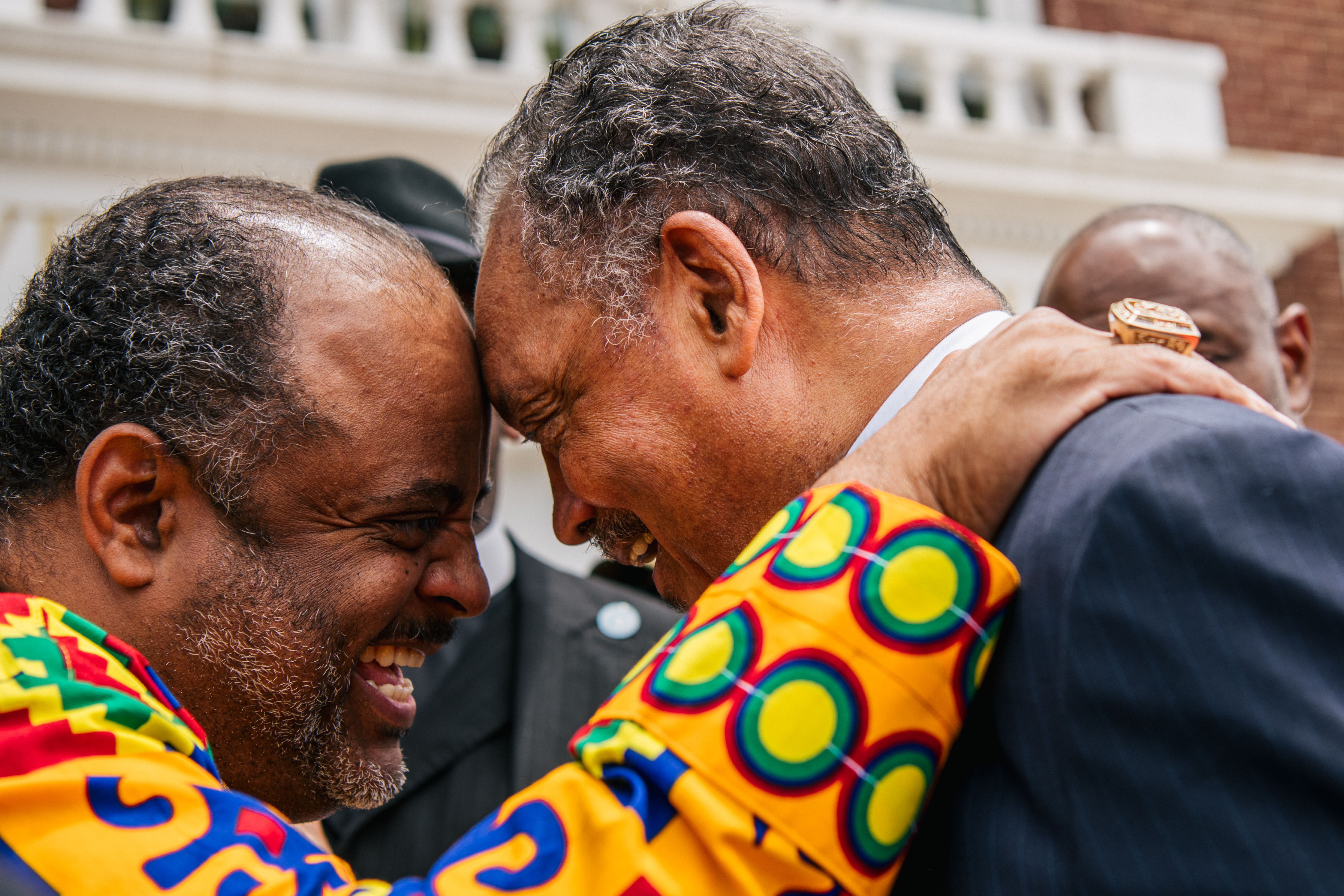Rev. Jesse Jackson laughs with journalist Roland Martin at the AME Church in the Greenwood district during commemorations of the 100th anniversary of the Tulsa Race Massacre on May 30