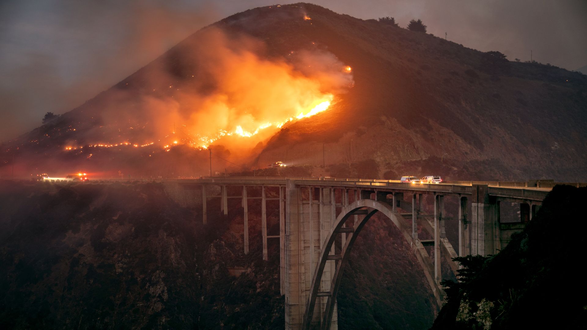 The Colorado Fiire burns down toward the Bixby Bridge in Big Sur, California, early Saturday morning