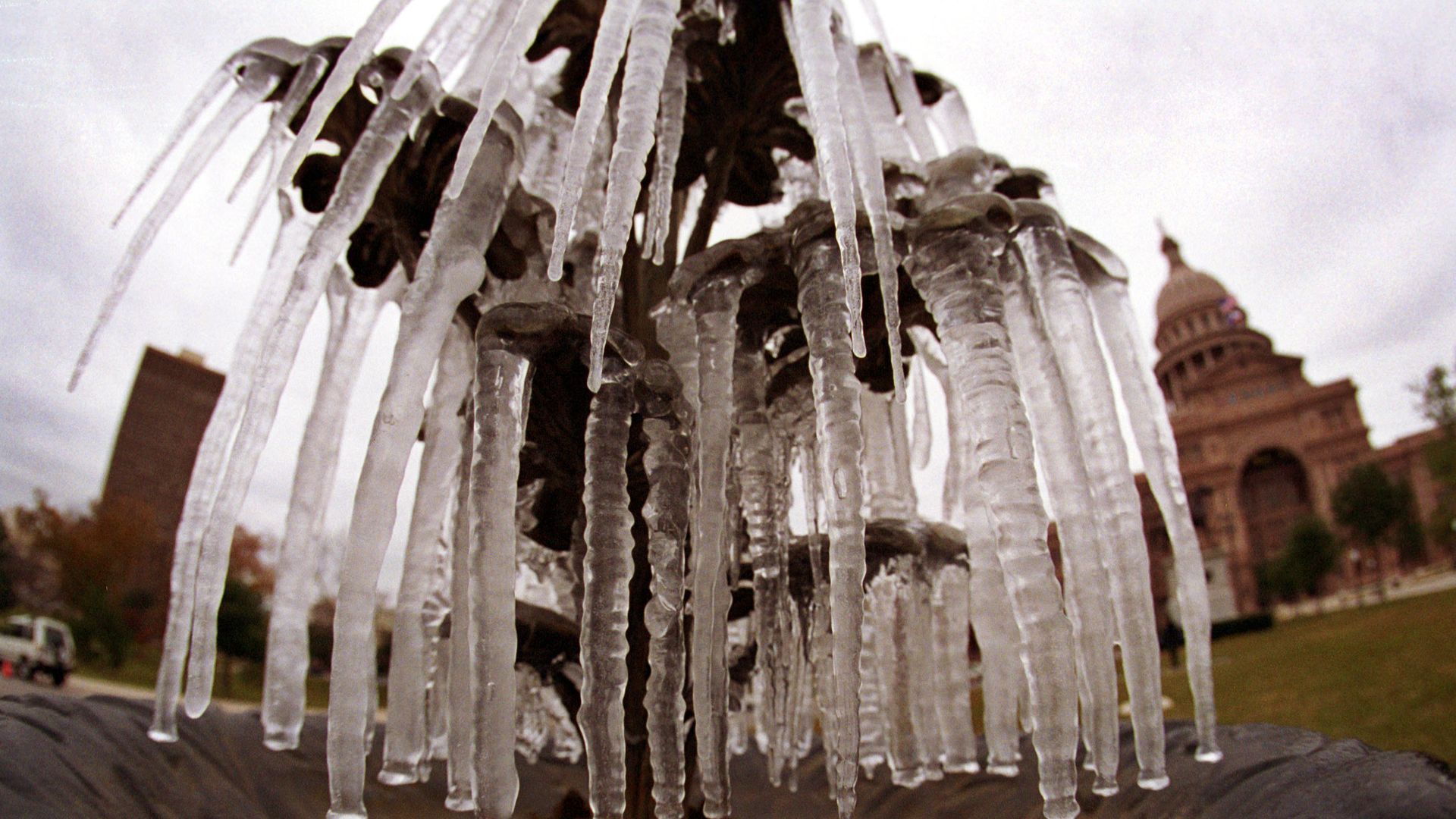 Icicles hang from a frozen water fountain in front of the state Capitol building in Austin.