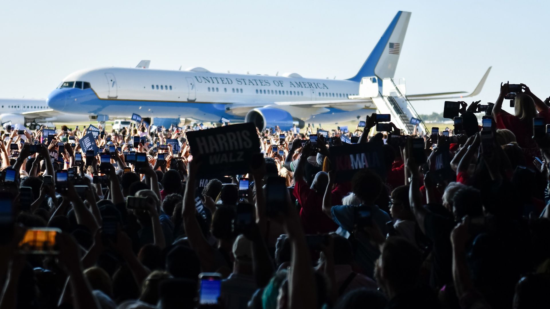 News photo of the Vice President's plane with a cheering crowd in front