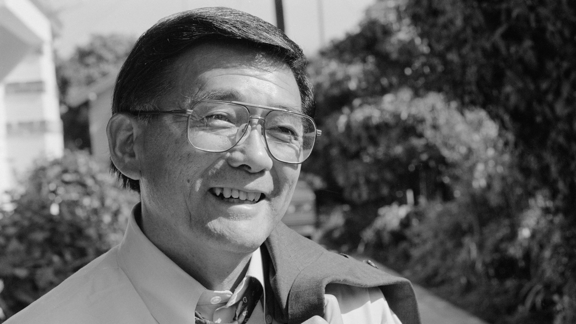 Black and white photo of Norman Mineta smiling