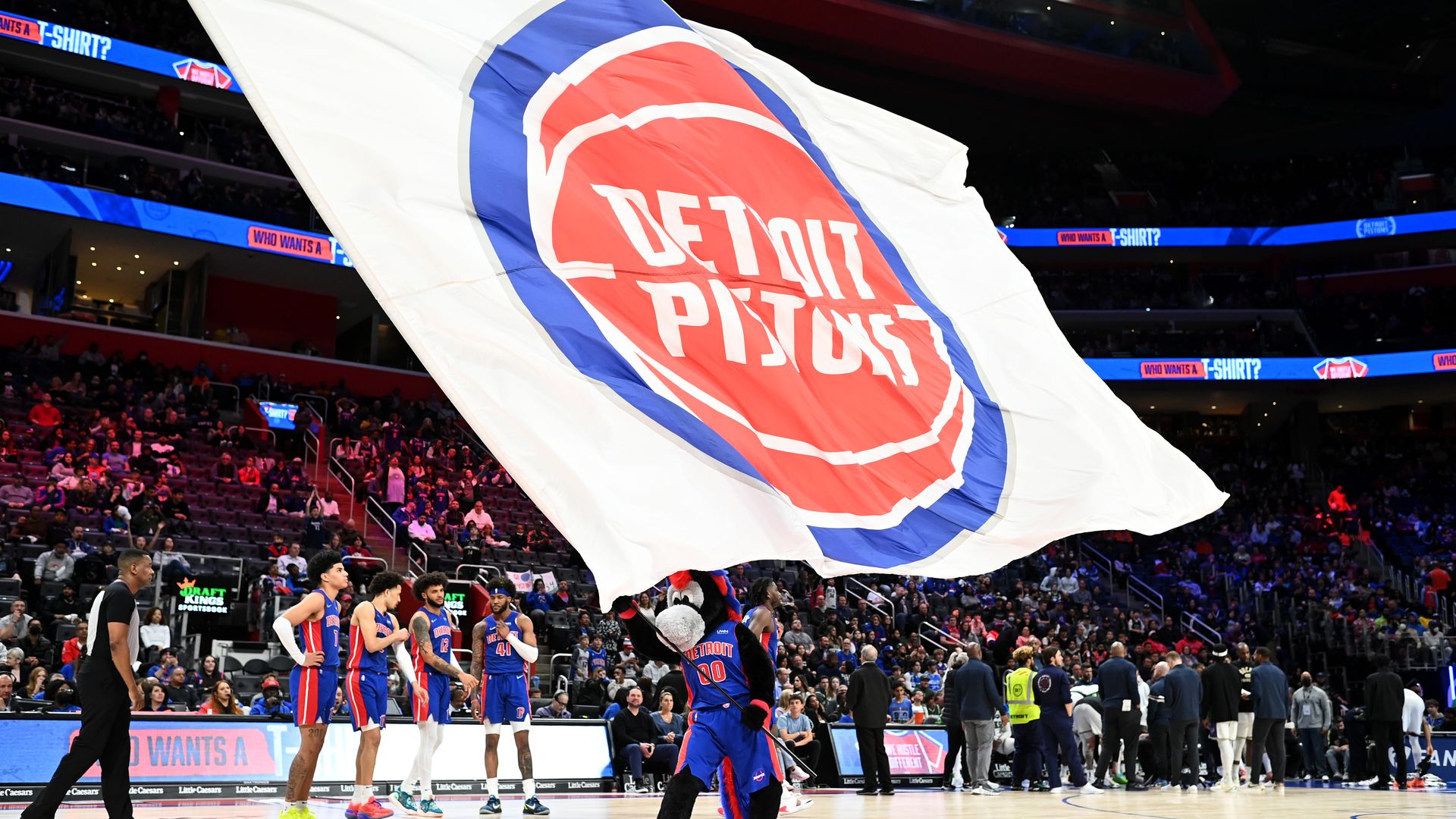 Pistons mascot Hooper holds a flag at center court