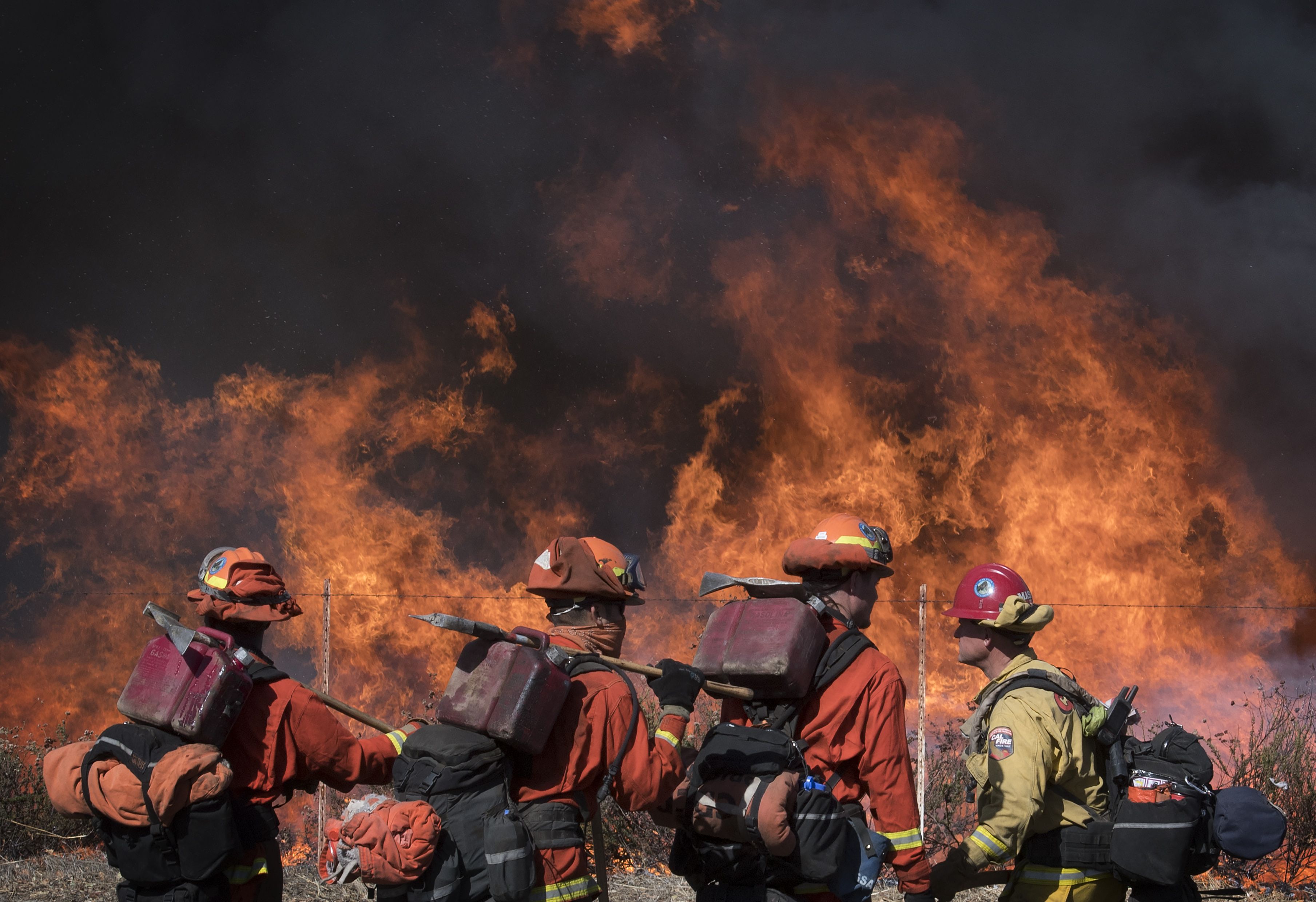 Inmate firefighters take a break while battling the 2019 Kincade Fire in Healdsburg, California