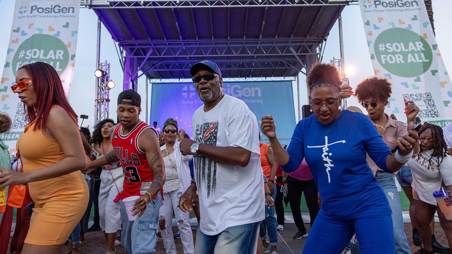 Photo shows people dancing at French Quarter Fest.