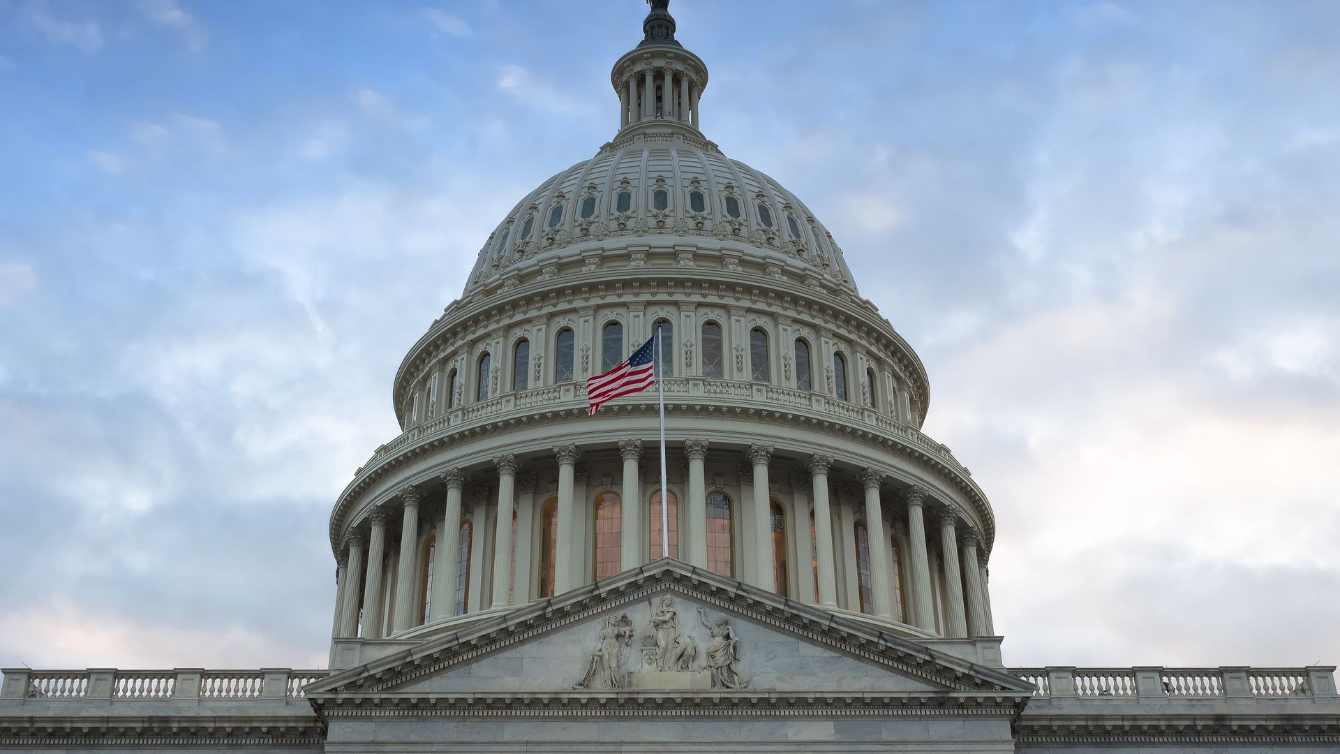 The dome of the Capitol building against a blue sky.