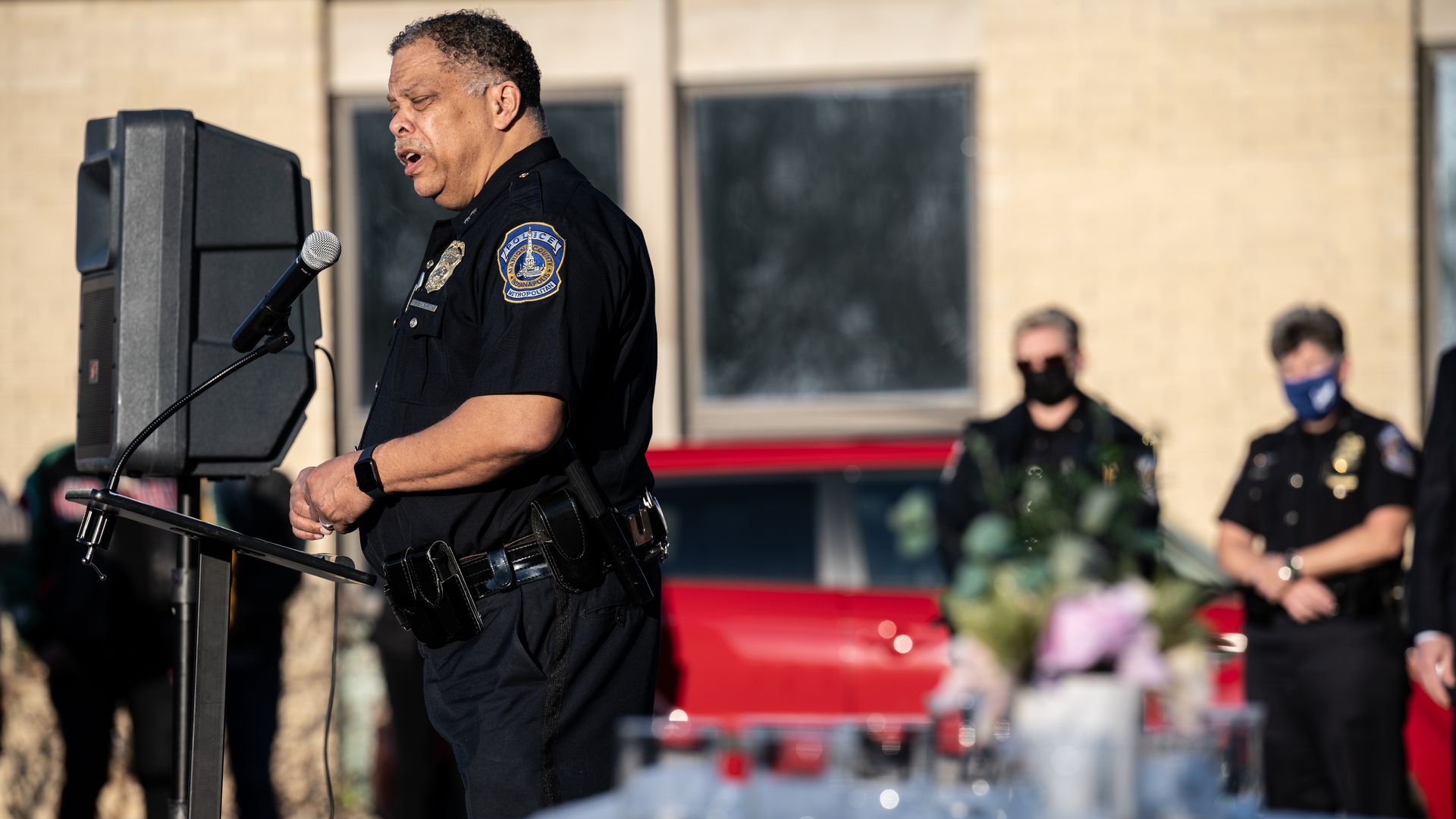 Photo of a police chief speaking at a public vigil