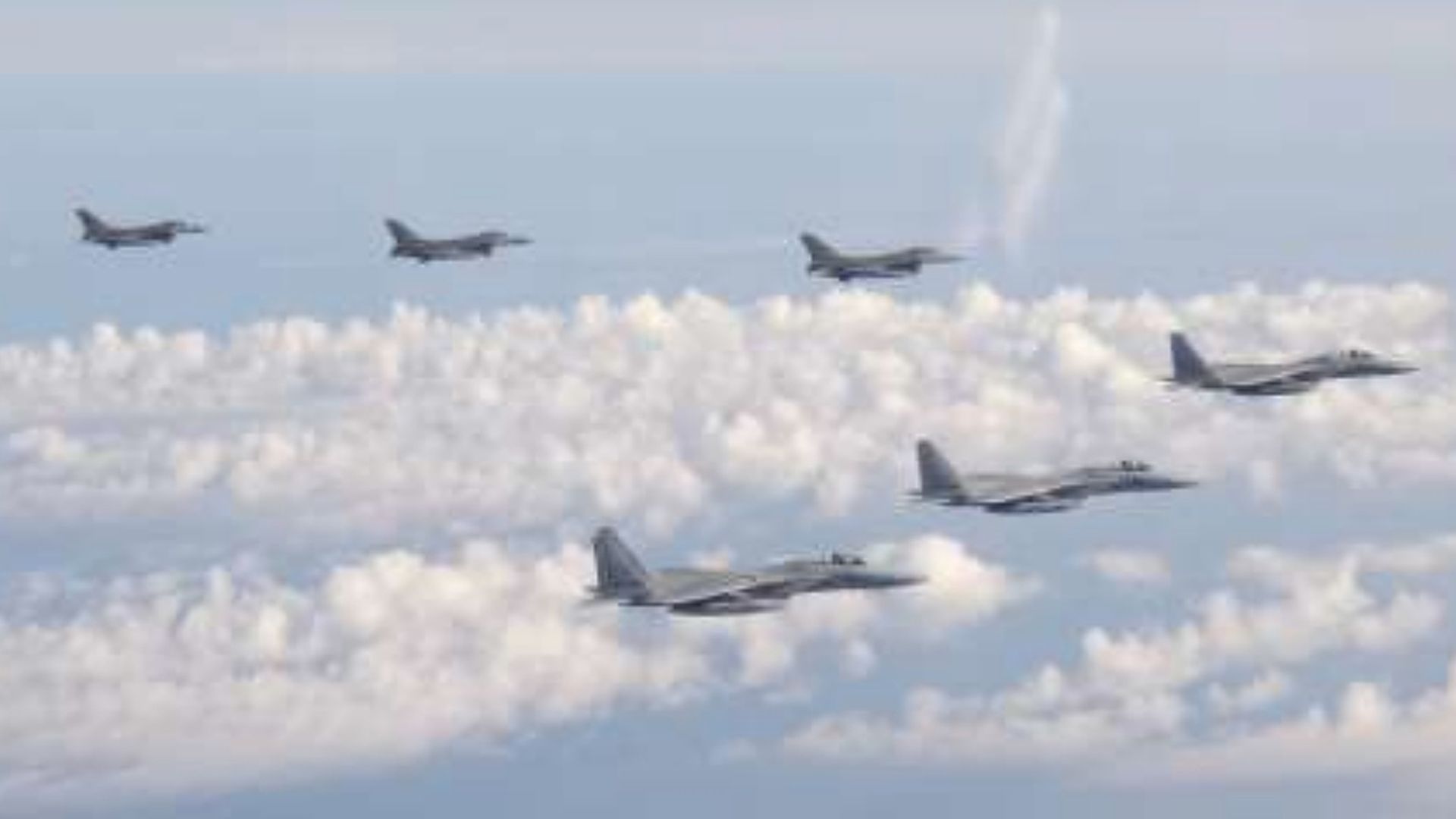 Three F-15 warplanes of the Japanese Self-Defense Force, front, and four F-16 fighters of the U.S. Armed Forces fly over the Sea of Japan on Wednesday, May 25, 2022.