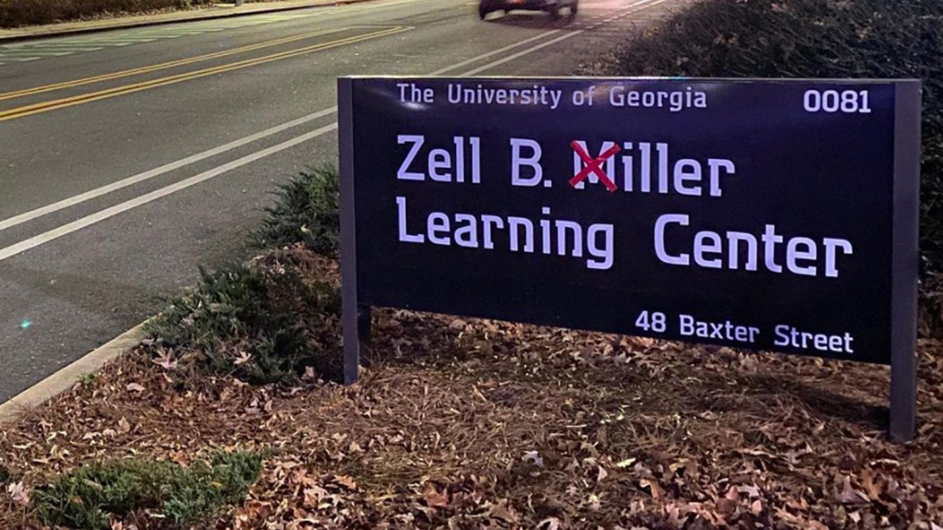 A sign for the Zell B. Miller Learning Center on the University of Georgia campus has the "M" in Miller crossed out with a red tape "X"