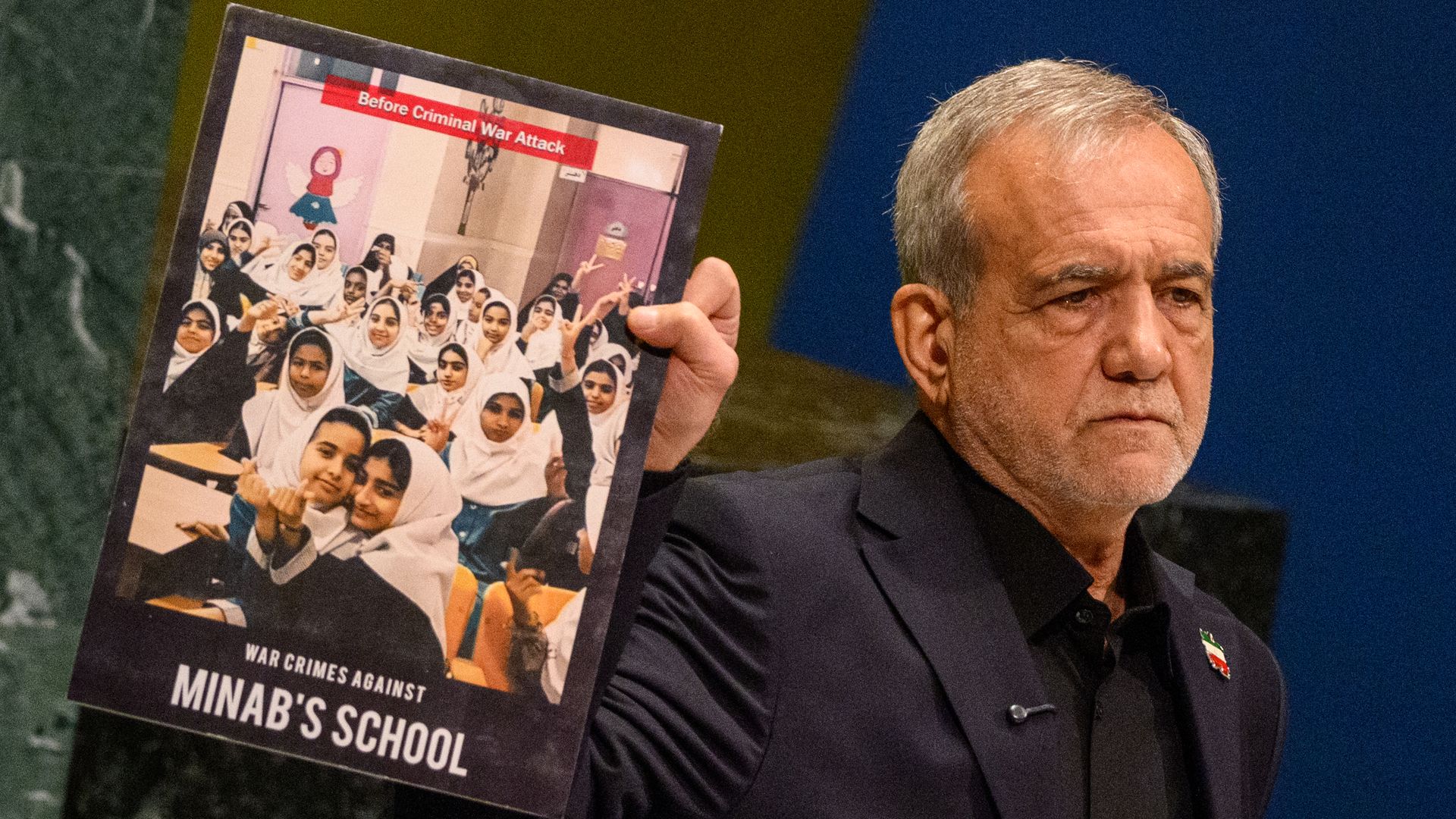 President of Iran Masoud Pezeshkian holds up a poster of a girl's school that was attacked while addressing the 81st session of the United Nations (U.N.) General Assembly at U.N. Headquarters on September 23, 2026 in New York City.