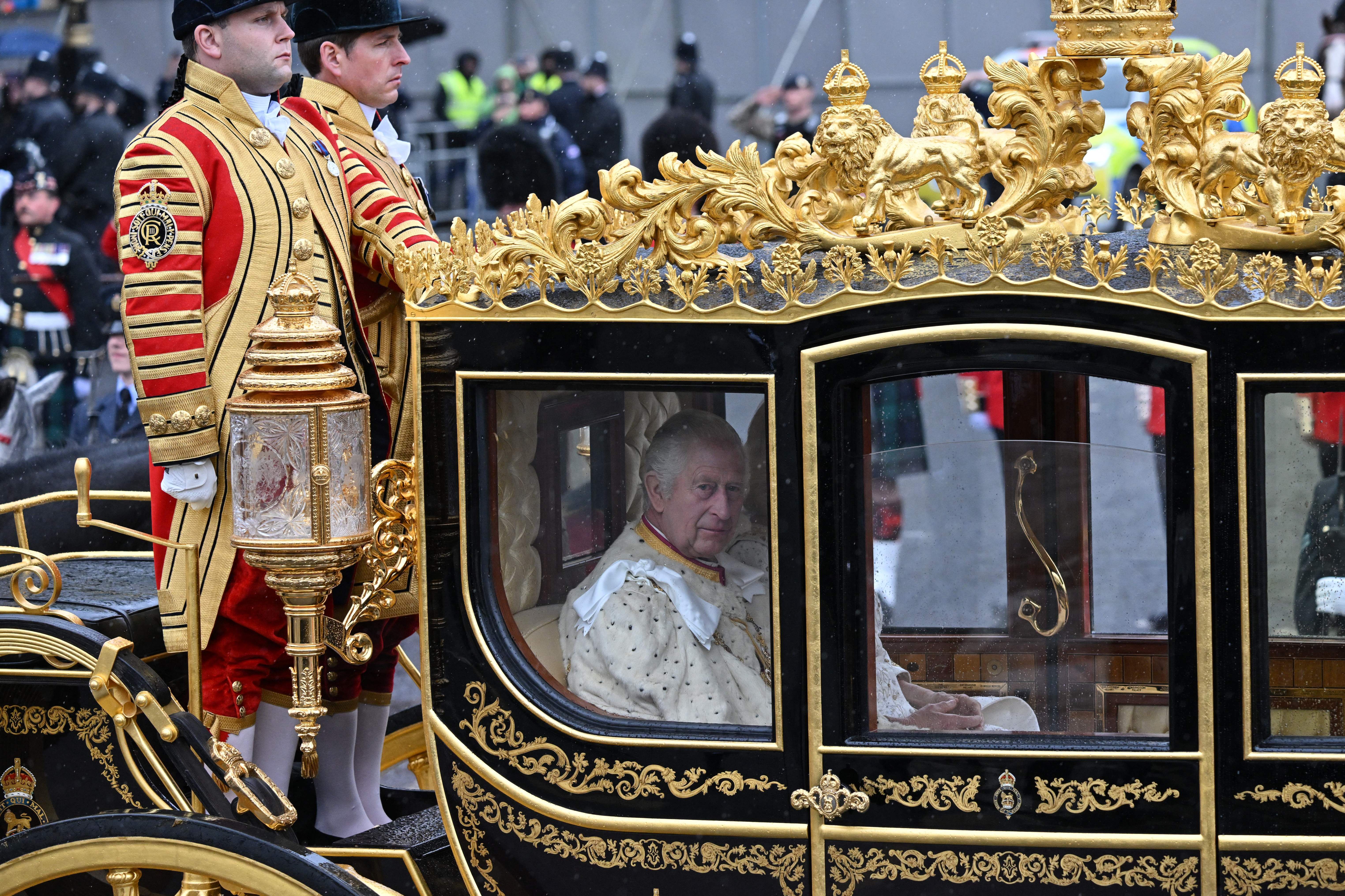 Britain's King Charles III and Britain's Camilla, Queen Consort ride in the Diamond Jubilee State Coach, during the 'King's Procession