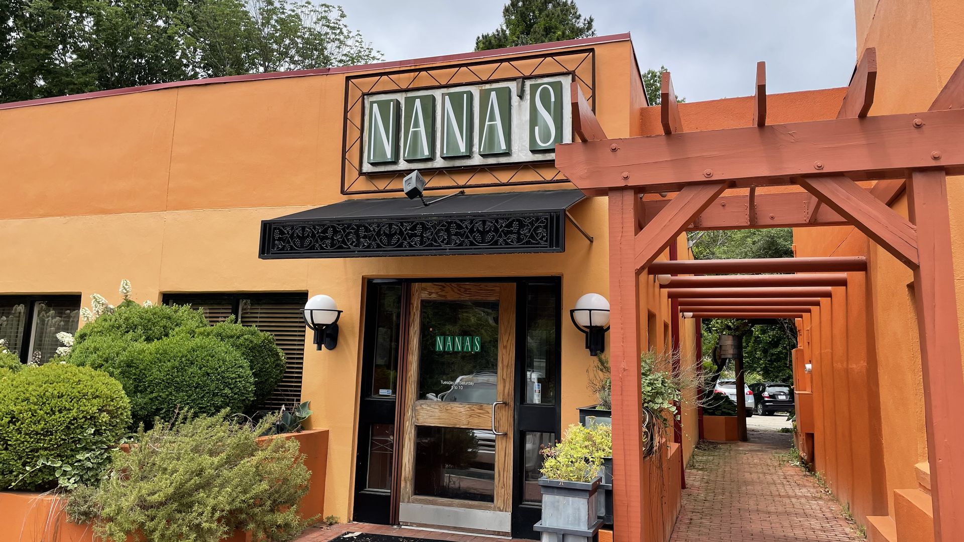 The front of an orange restaurant called Nana's 