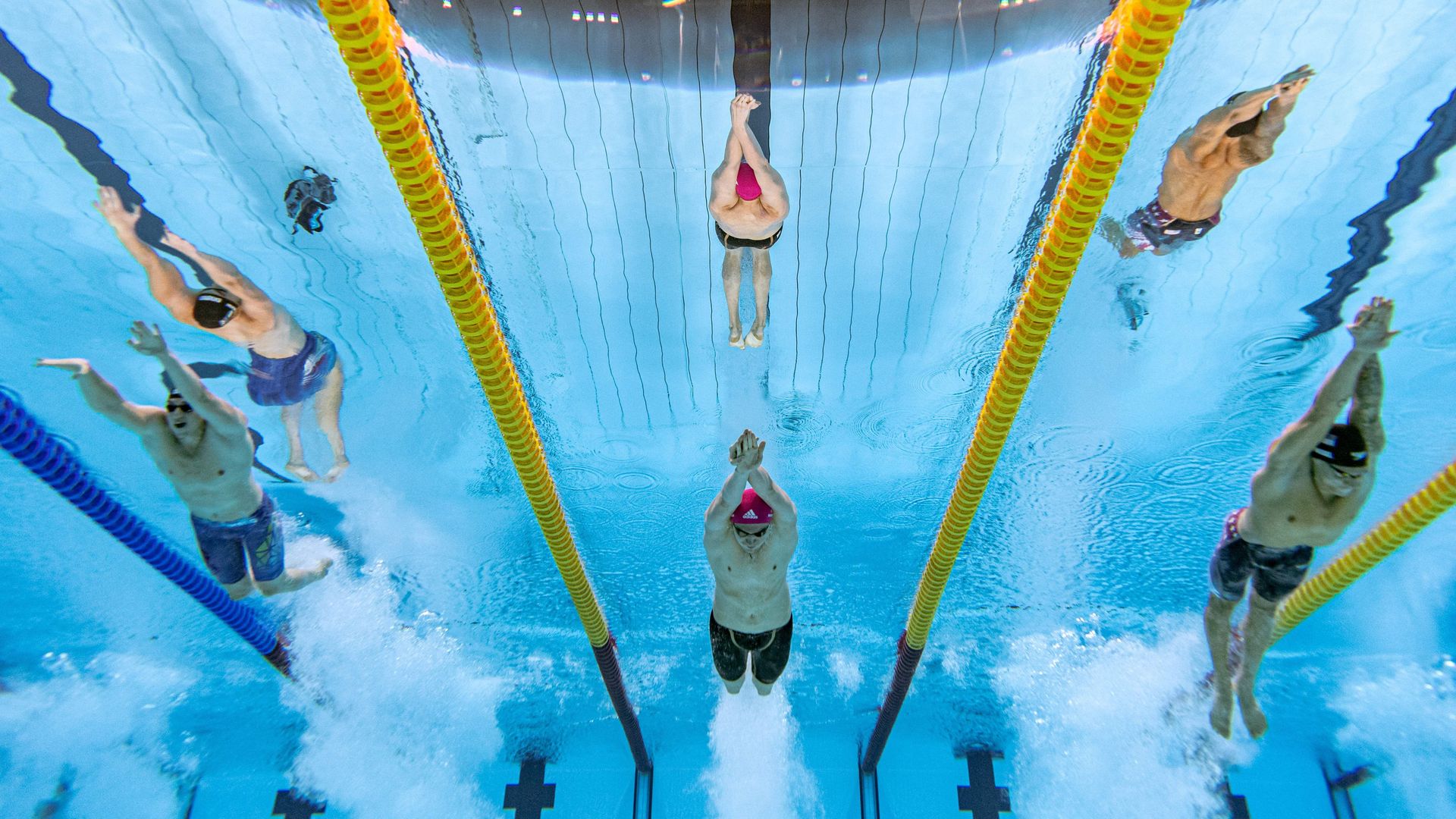 An underwater view of swimmers including Caeleb Dressel (R) in the final of the Olympic Tokyo Games men's 100m freestyle, which the American swimmer won on July 29.