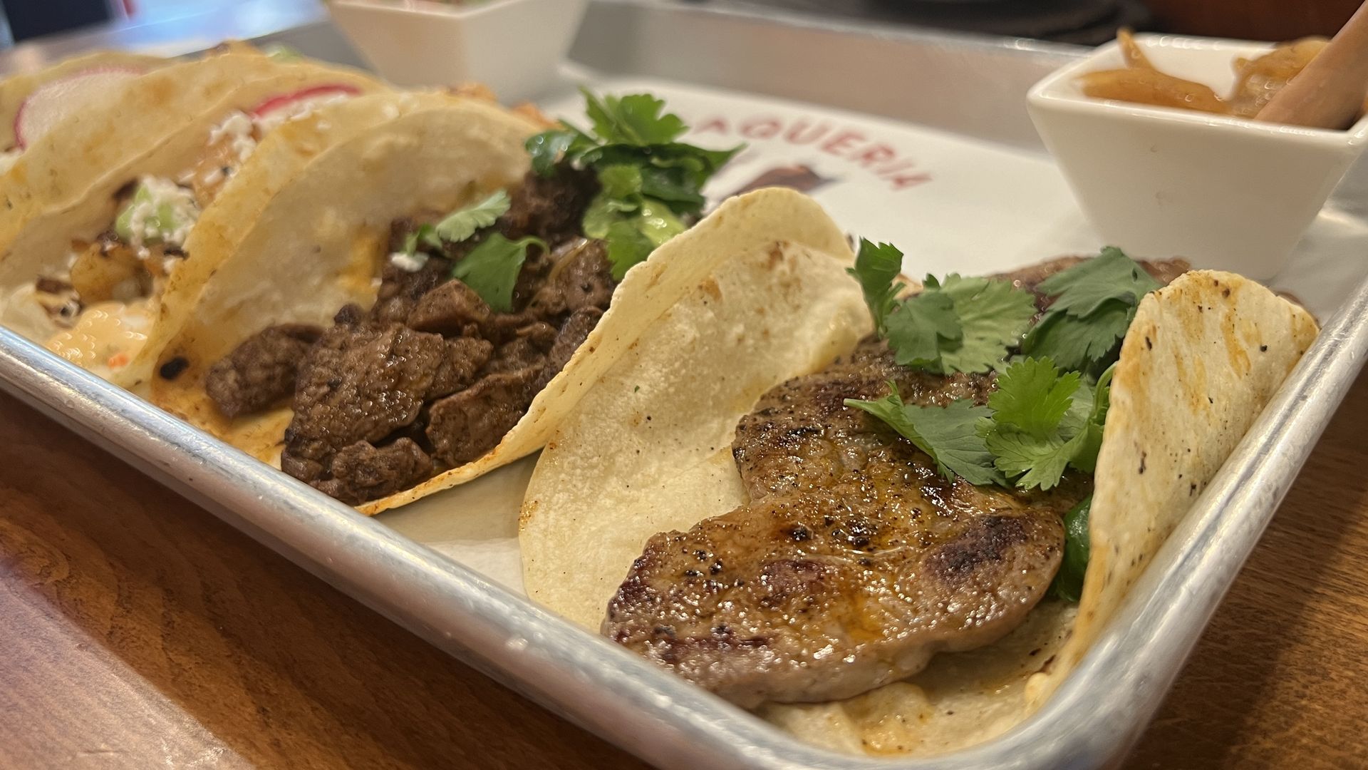 Bistec tacos with cilantro in a tray from Taqueria Catrinas