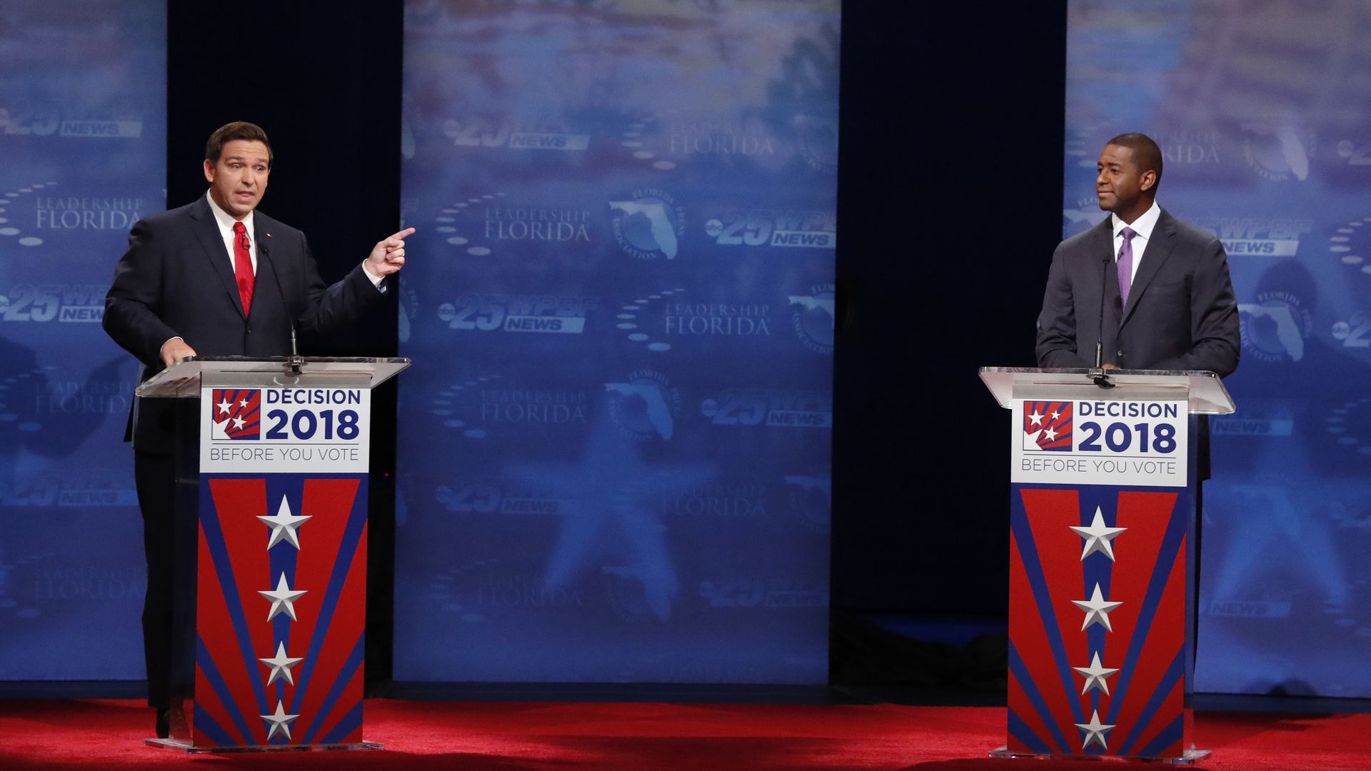 Ron DeSantis and Andrew Gillum on a debate stage.