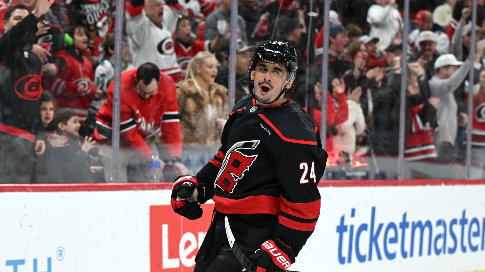 Seth Jarvis #24 of the Carolina Hurricanes celebrates after scoring during a home NHL game.