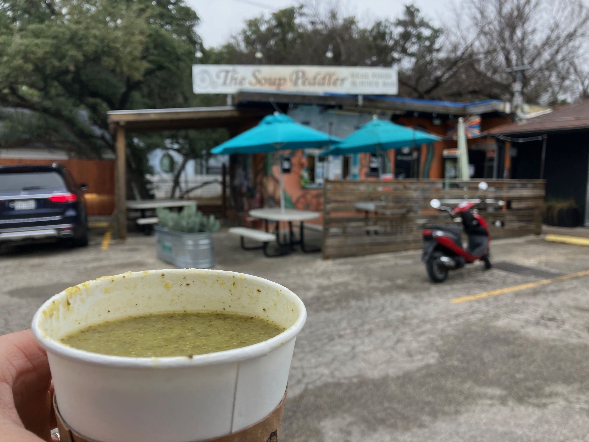 A cup of green broth from Soup Peddler.