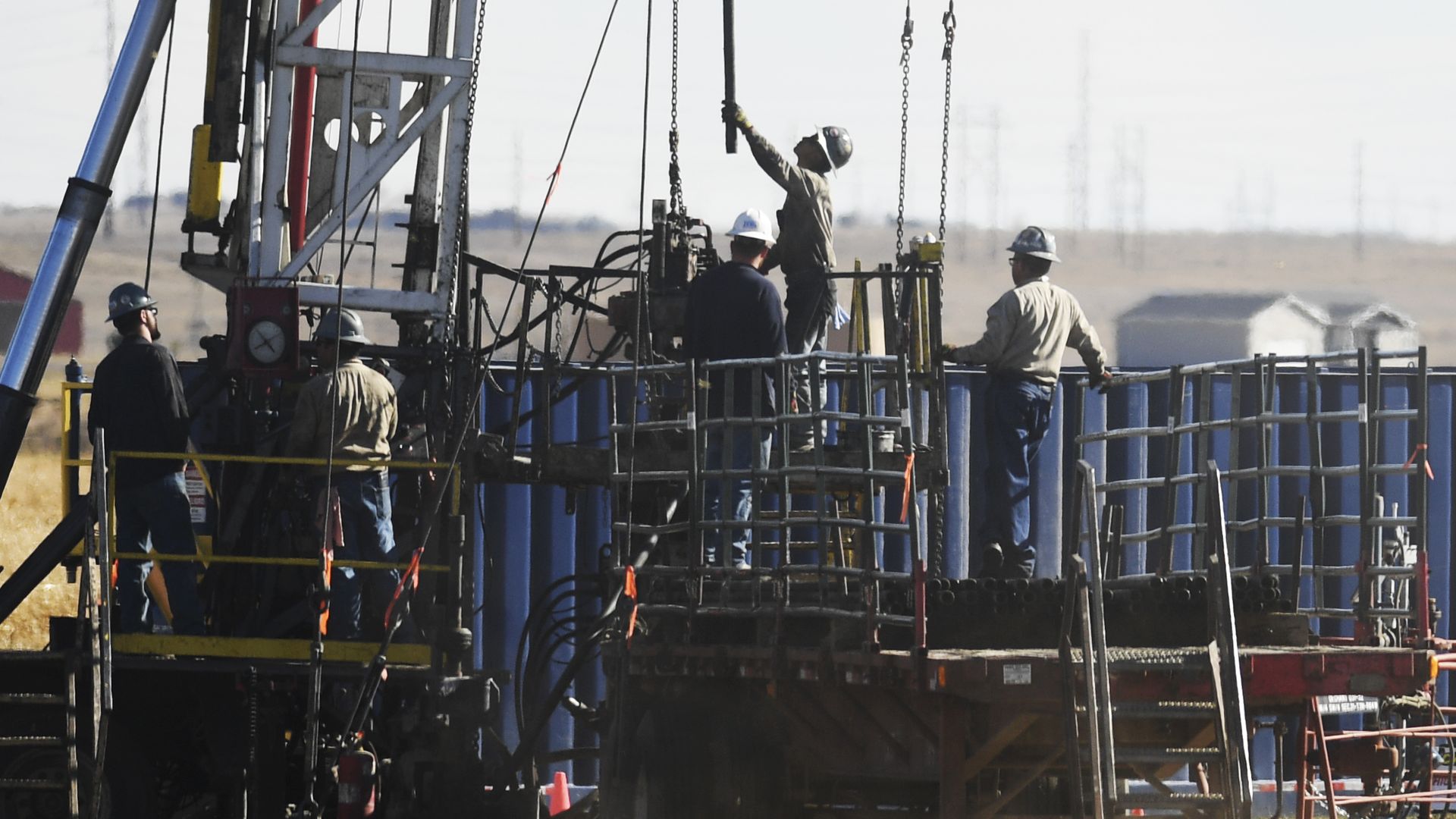 Oil and gas workers work on a rig in Colorado
