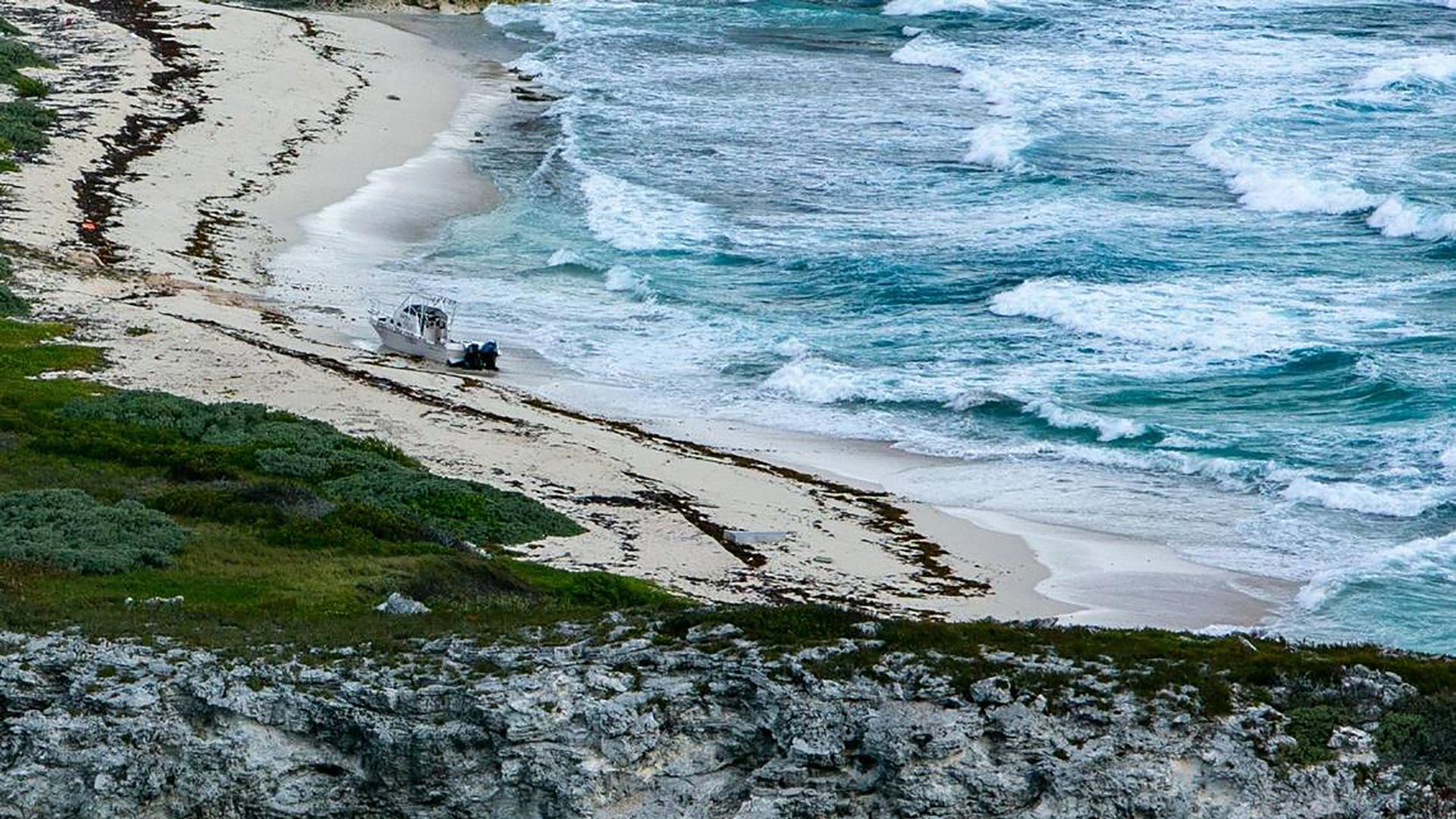 An abandoned vessel on a beach on a deserted island is seen during a U.S. Coast Guard reconnaissance flight on April 22, 2022, over the Florida Straits and the Bahamas. (Getty Images)