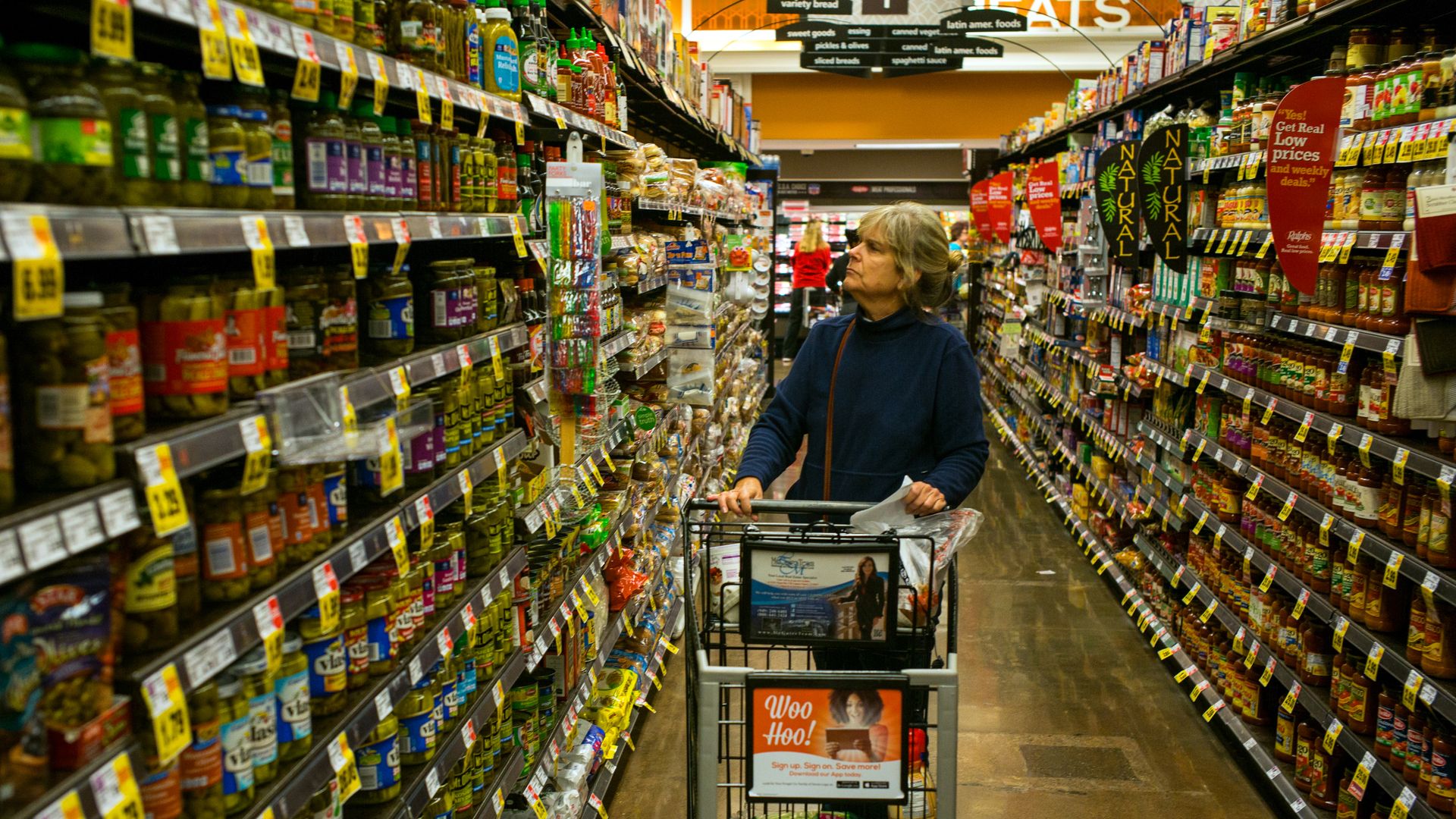 A woman browses products in an aisle
