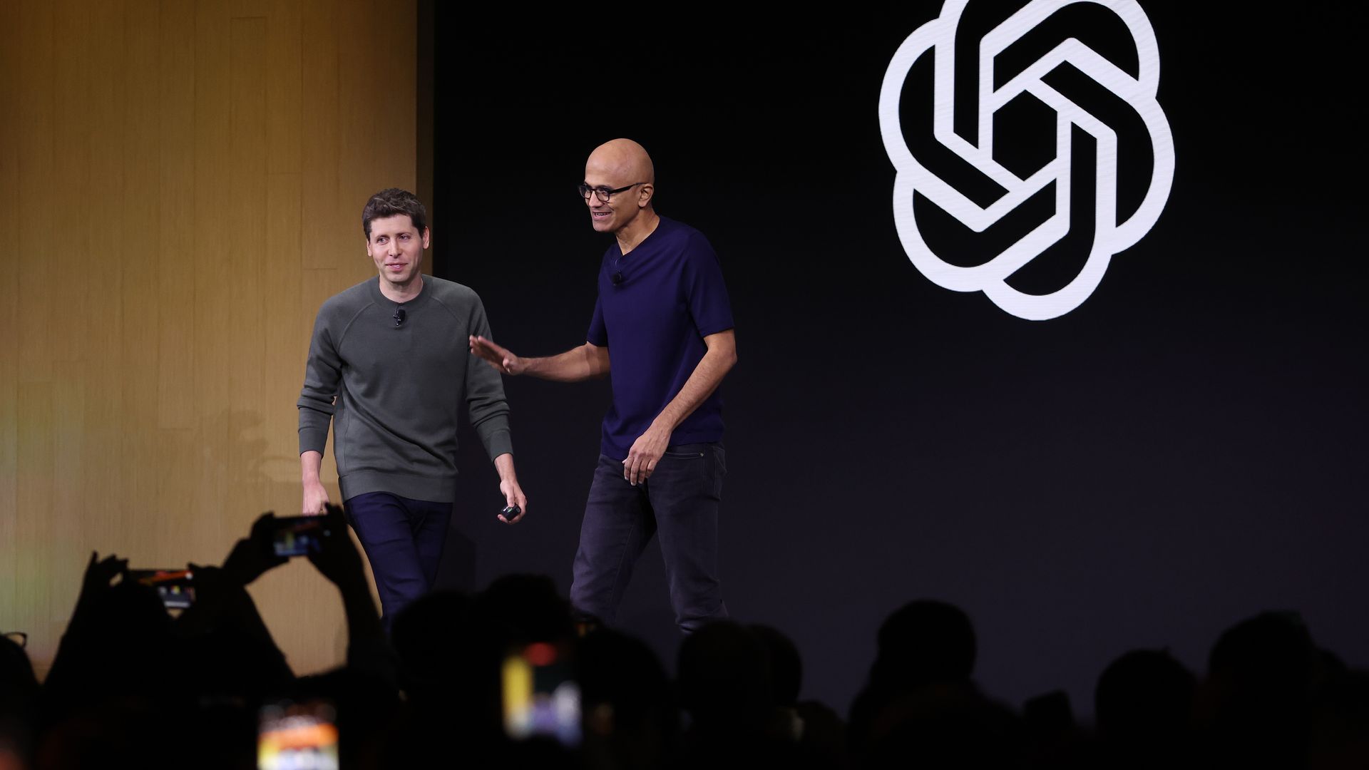 Photo of Sam Altman and Satya Nadella on stage with the OpenAI logo behind them. 