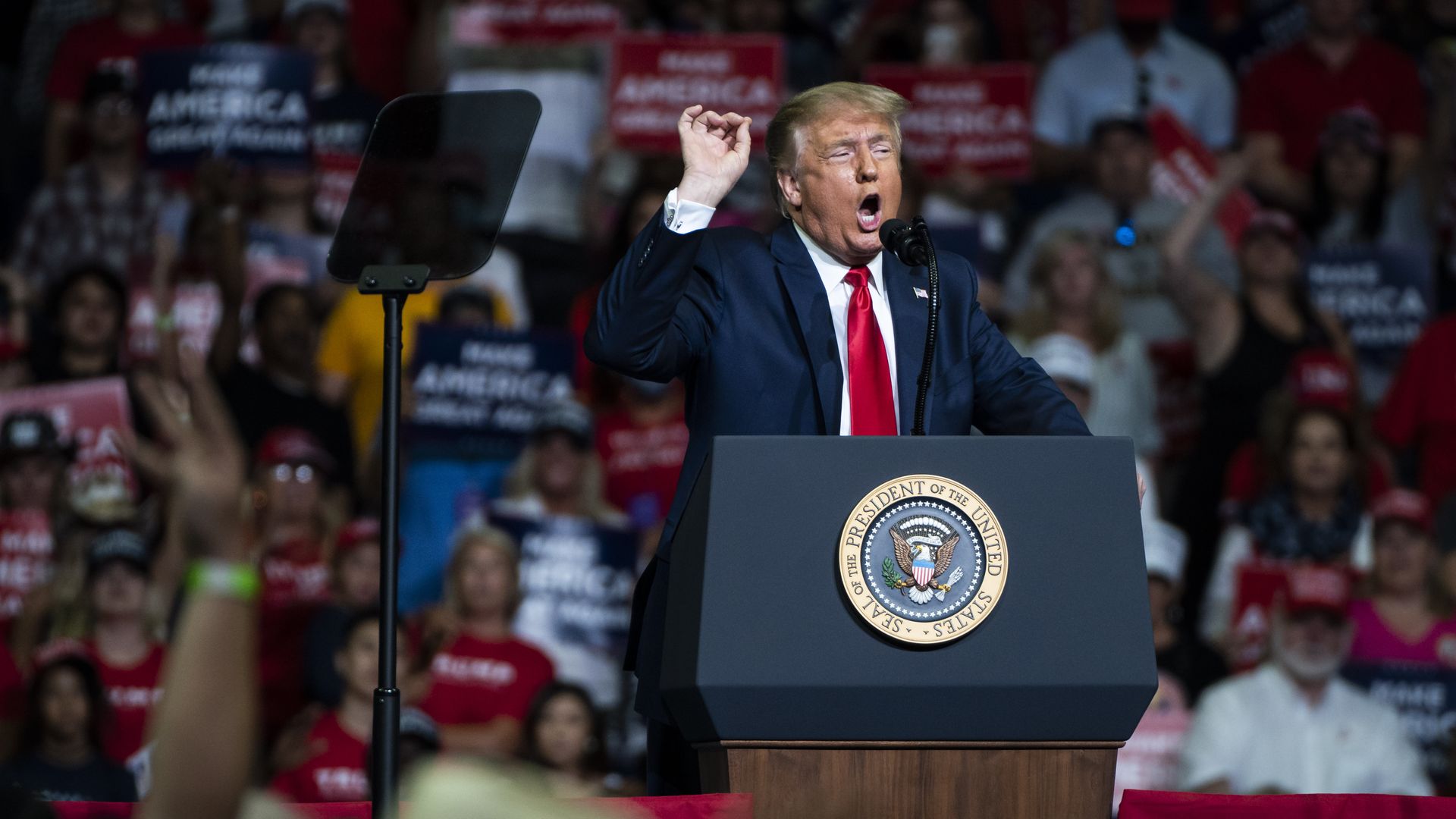 Trump at the podium of a MAGA rally