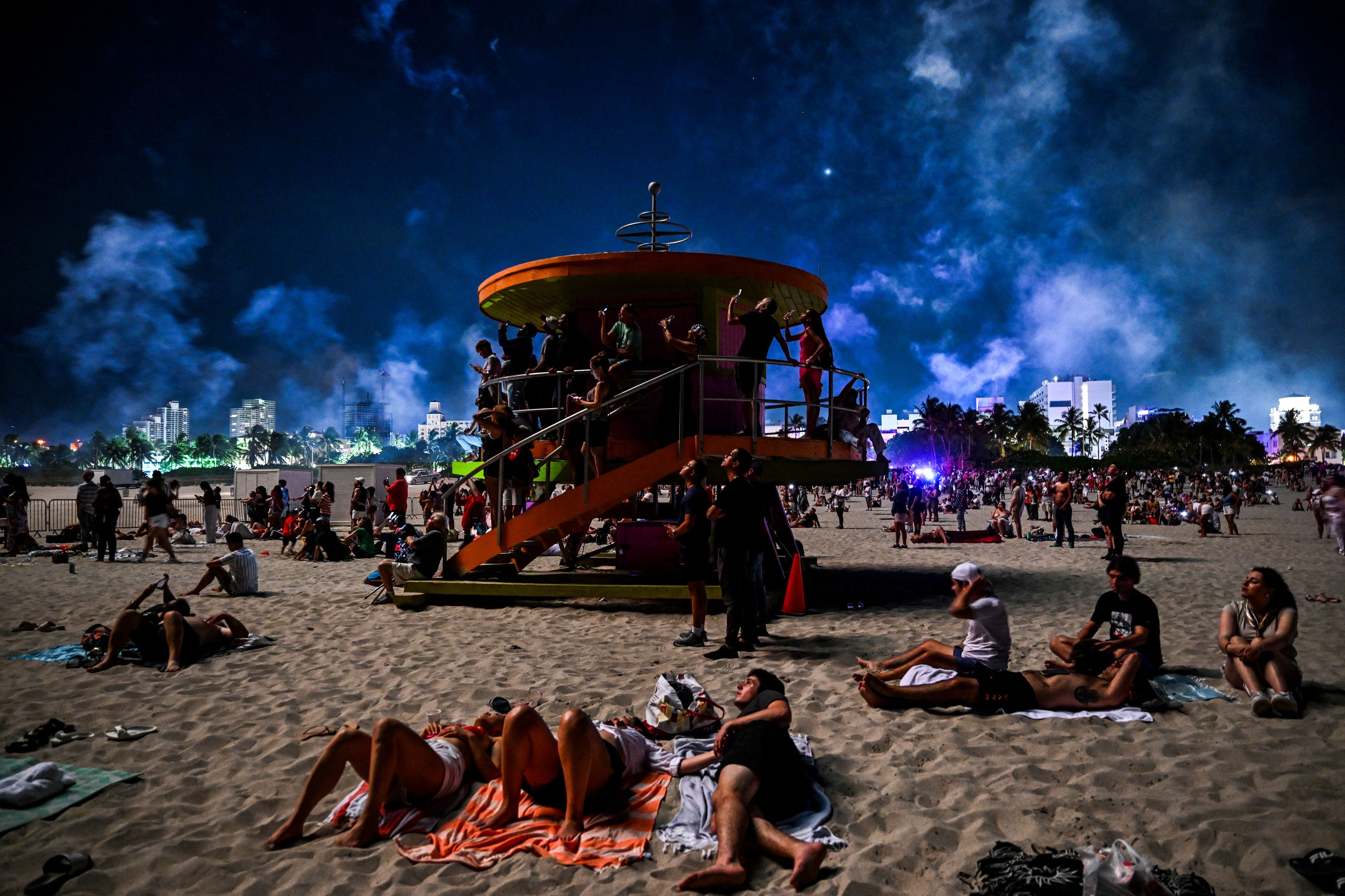 People gather to watch Independence Day fireworks on South Beach in Miami Beach, Florida on July 4, 2023.