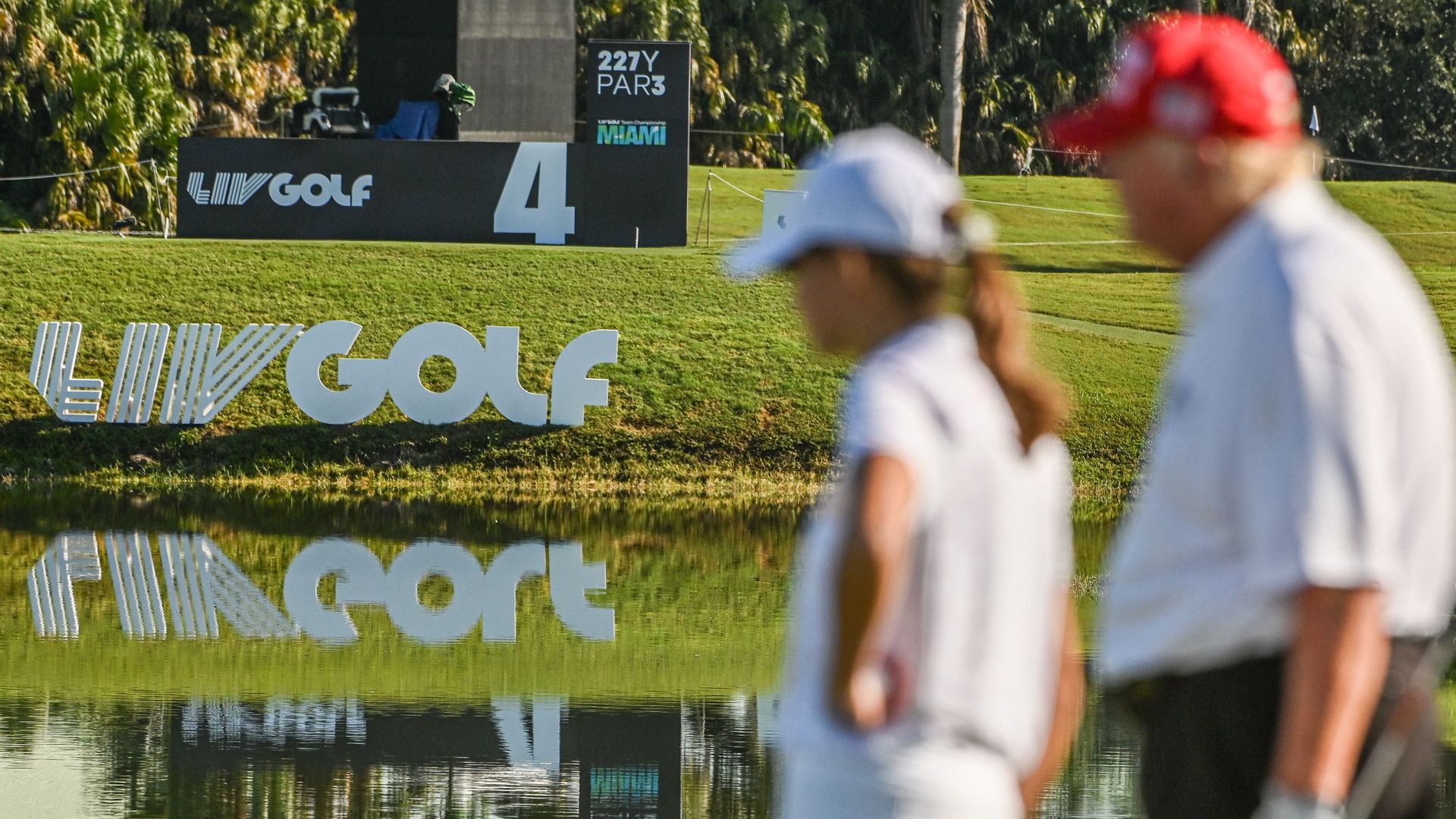 Former US President Donald Trump (R), with his and granddaughter Kai Trump (2nd R), plays golf at Trump National Doral Miami golf club