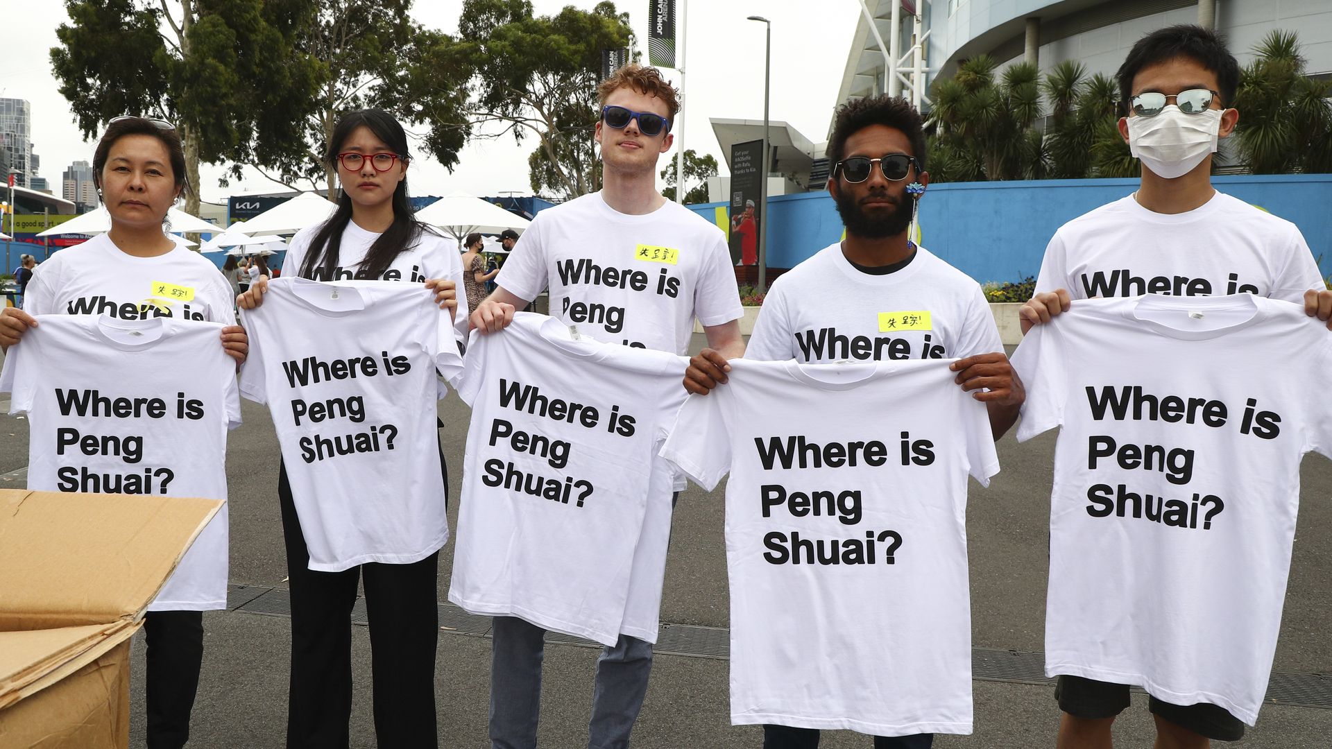 Protesters holding "Where is Peng Shuai?" t shirts