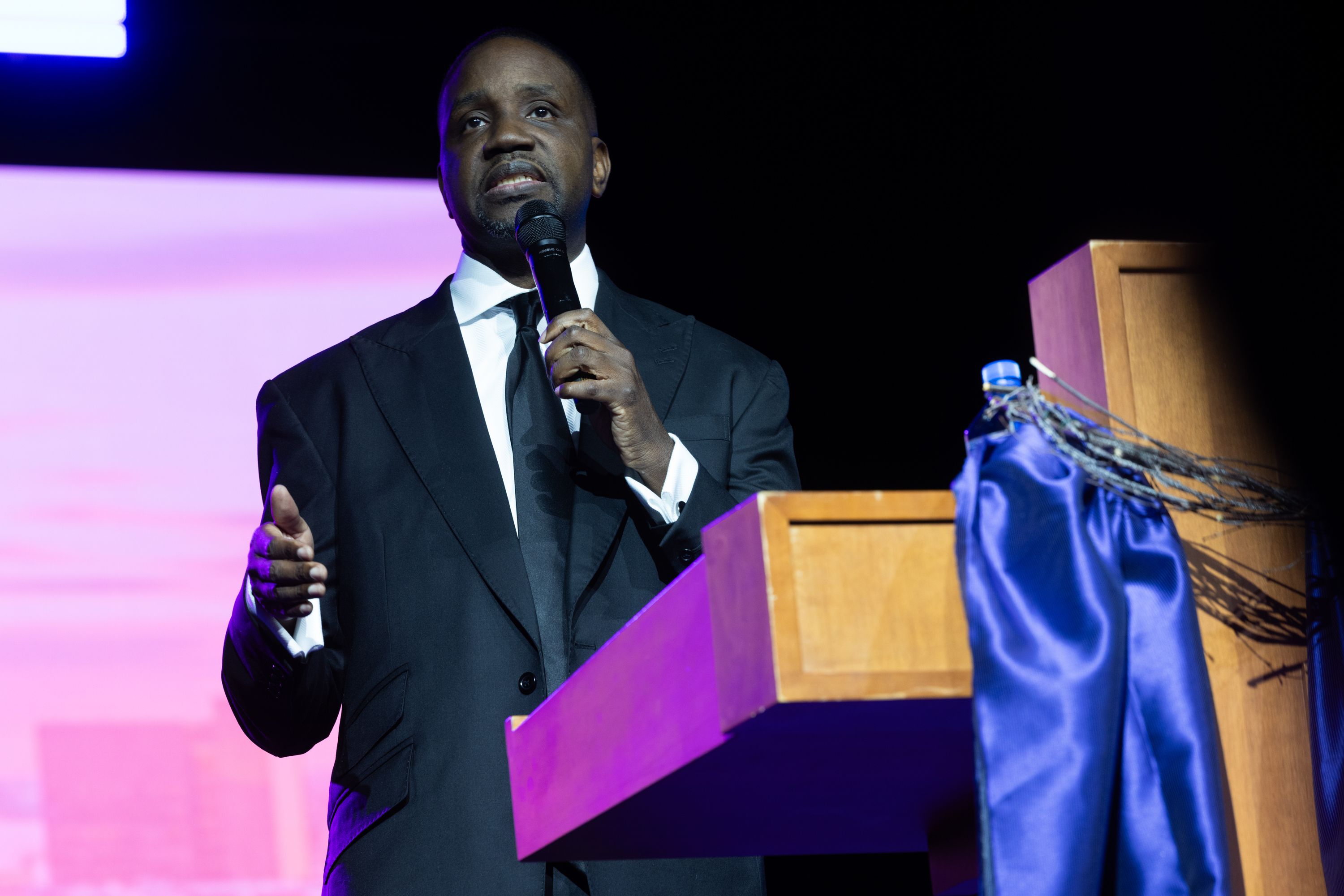 Kinloch is shown at a podium speaking