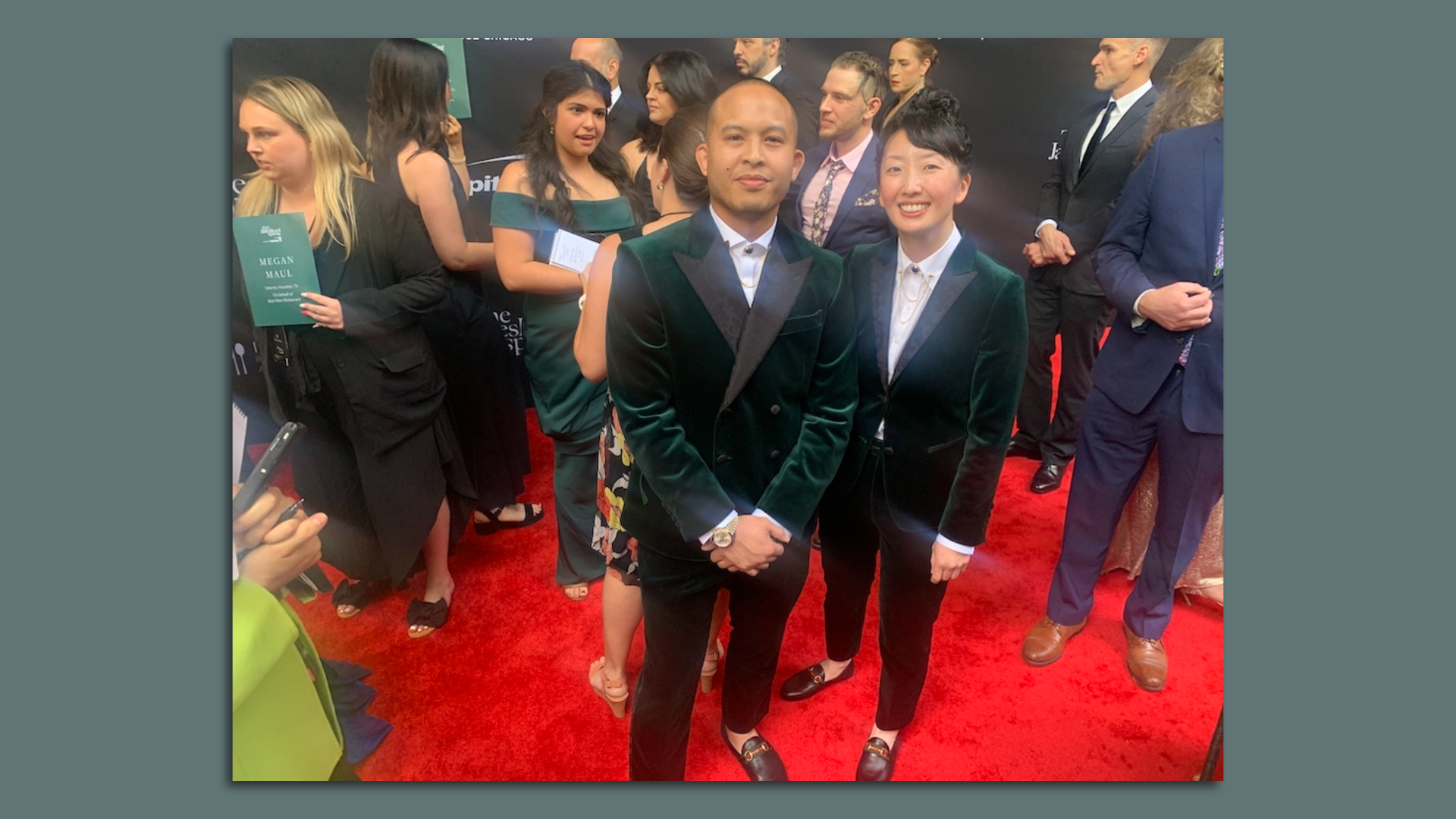 Kasama co-owners Tim Flores and Genie Kwong post on the red carpet in matching green velvet suits.