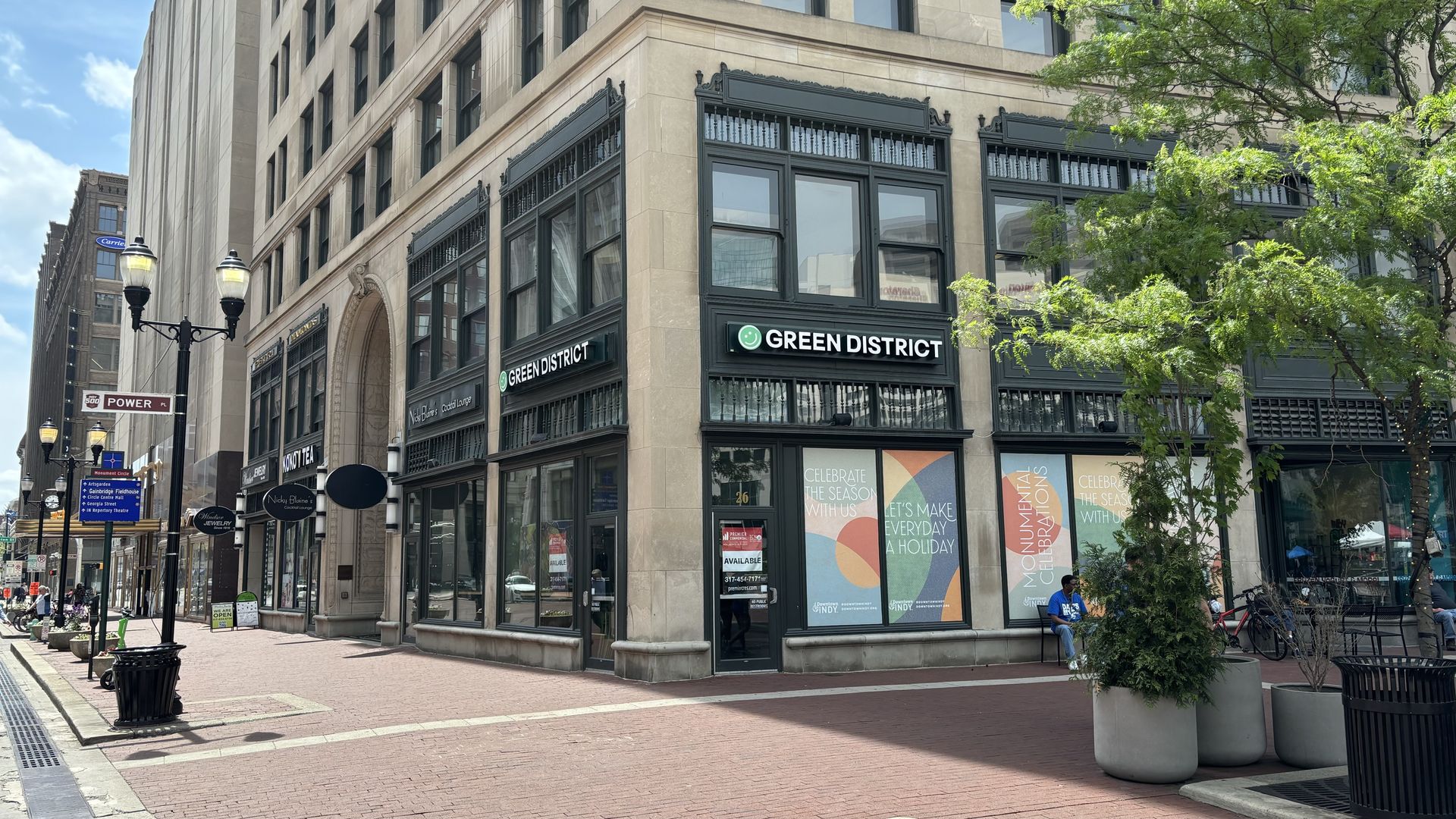 A building on a corner with a Green District sign