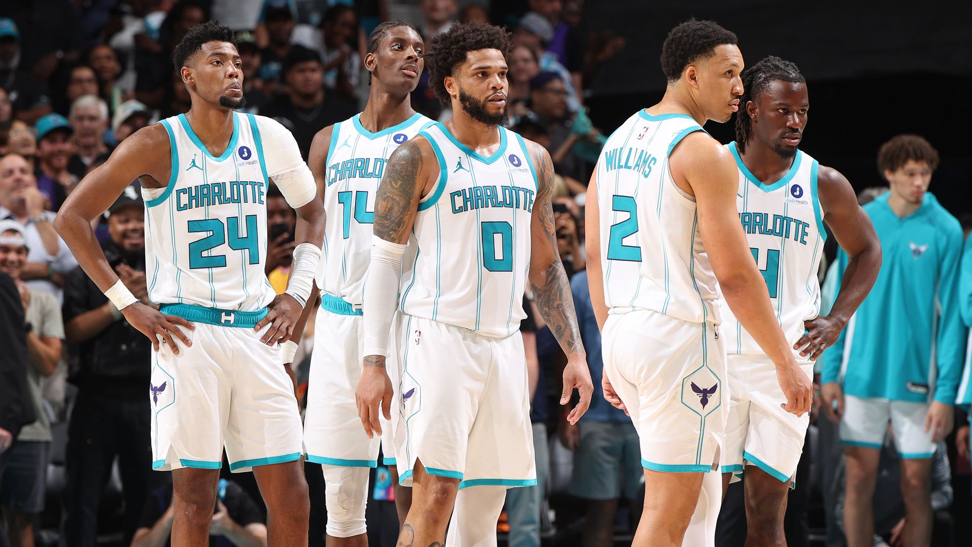 Brandon Miller #24, Moussa Diabate #14, Miles Bridges #0, Grant Williams #2, and Sion James #4 of the Charlotte Hornets looks on during the game against the Miami Heat during the Play-In Tournament on April 14, 2026 at Spectrum Center in Charlotte, North Carolina. 
