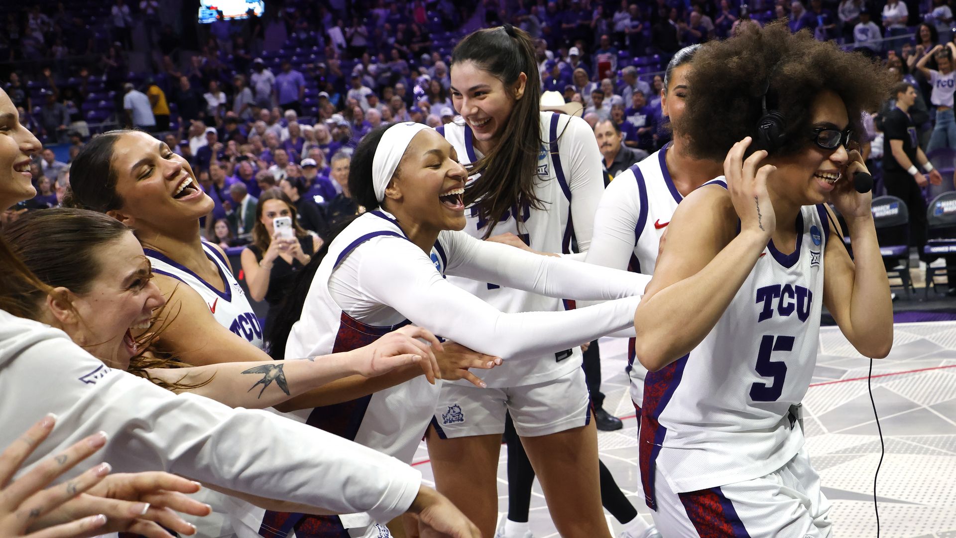 Olivia Miles is mobbed by teammates following the overtime victory over the Washington Huskies at Schollmaier Arena in Fort Worth.