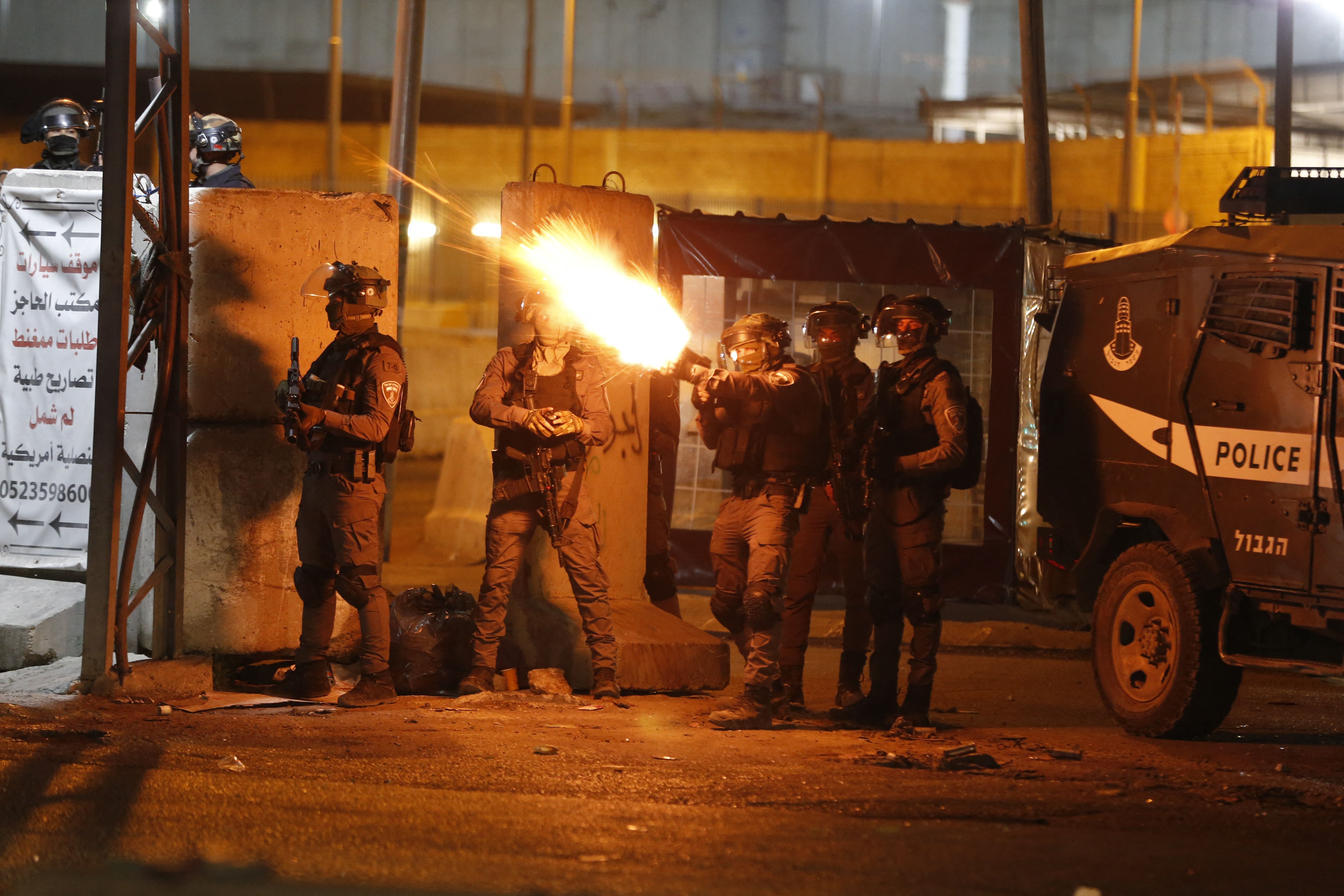  Israeli oldiers fire tear gas at Palestinian demonstrators at the Qalandiya checkpoint between Ramallah and Jerusalem, in the occupied West Bank, on May 11. 