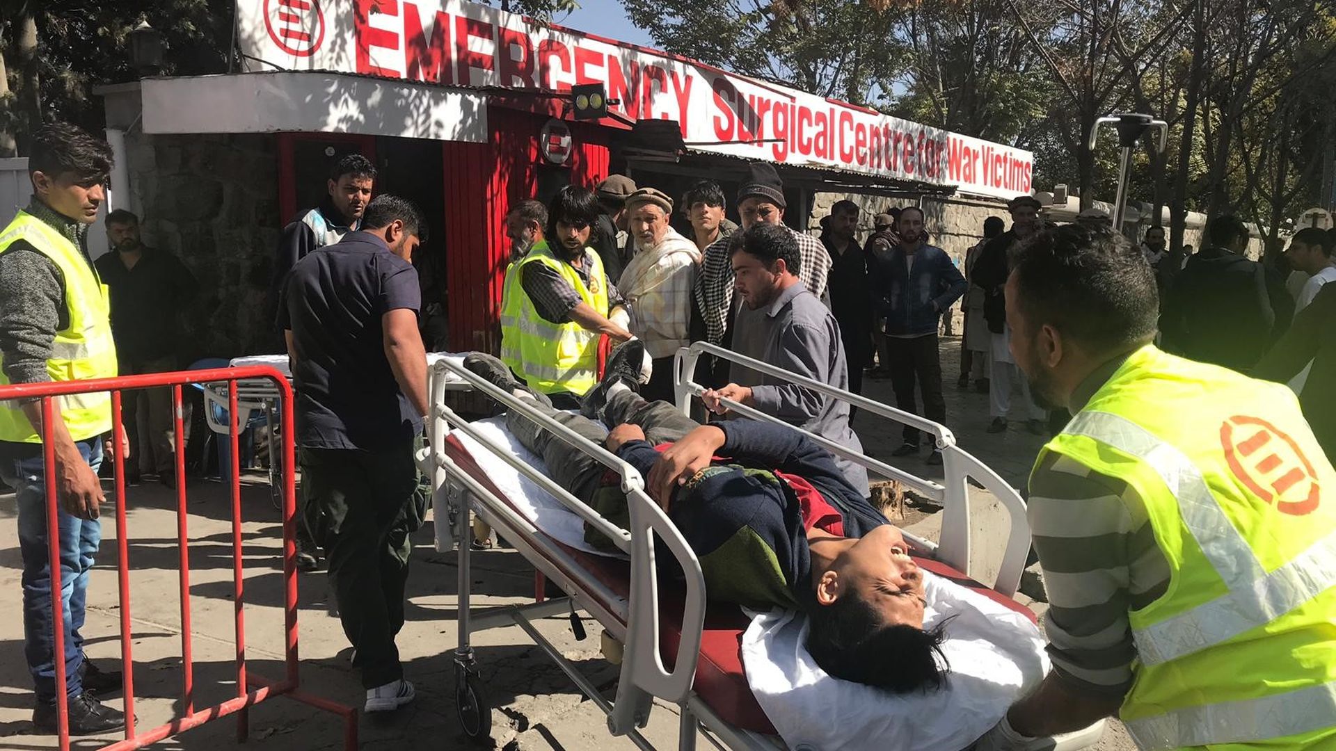 A wounded person being carried on a stretcher.