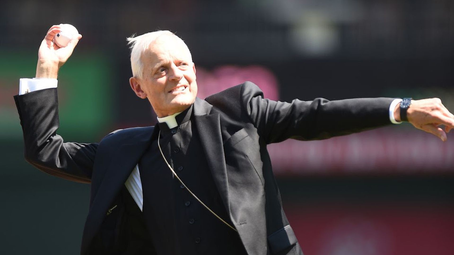Cardinal Wuerl throws a baseball pitch. 