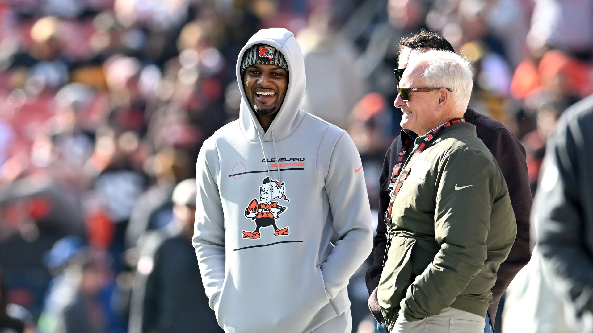 Deshaun Watson and Jimmy Haslam stand on the football field laughing. 