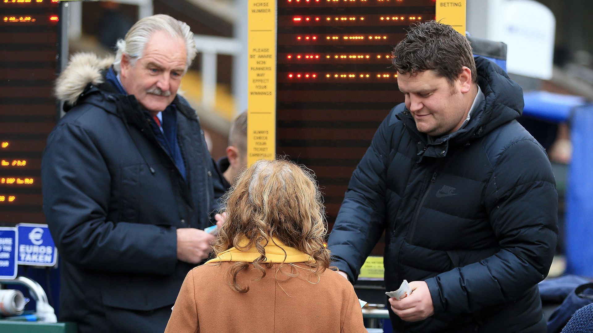 A woman placing a bet at a race