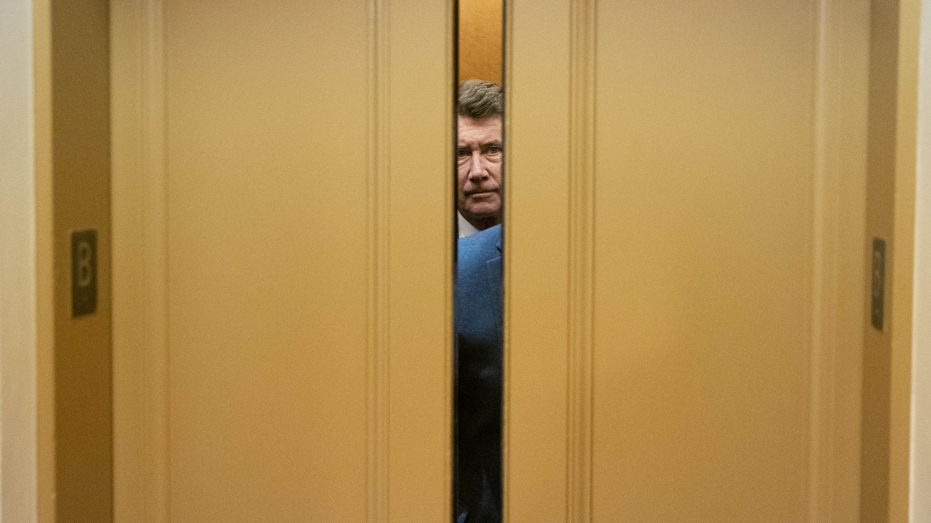 Sen. Bill Hagerty is seen between a set of closing Senate elevator doors.