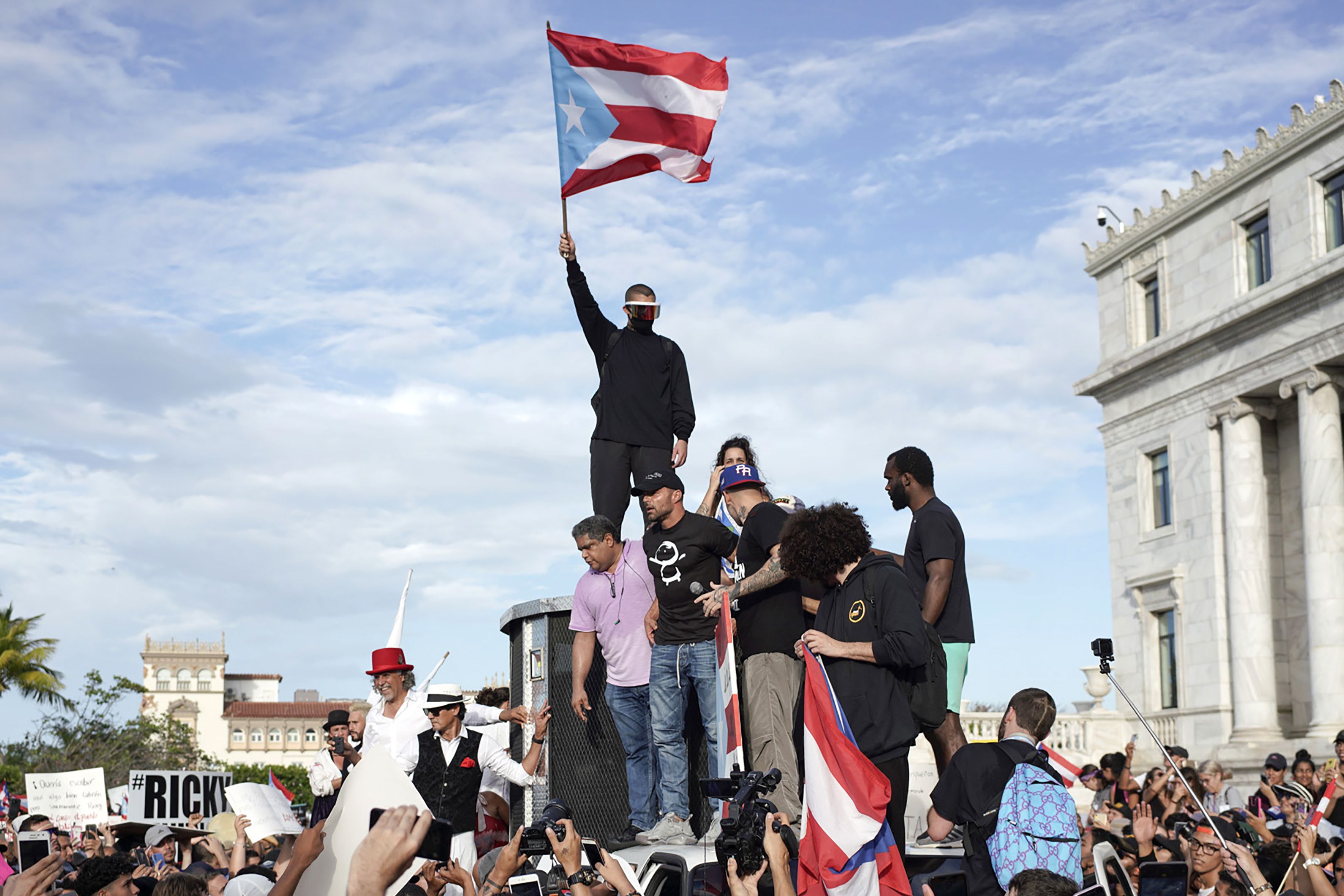 Puerto Rican singer Ricky Martin (C), Puerto Rican rapper Rene Perez, aka Residente, (R) Puerto Rican reggaeton singer Bud Bunny (top) at the protest.