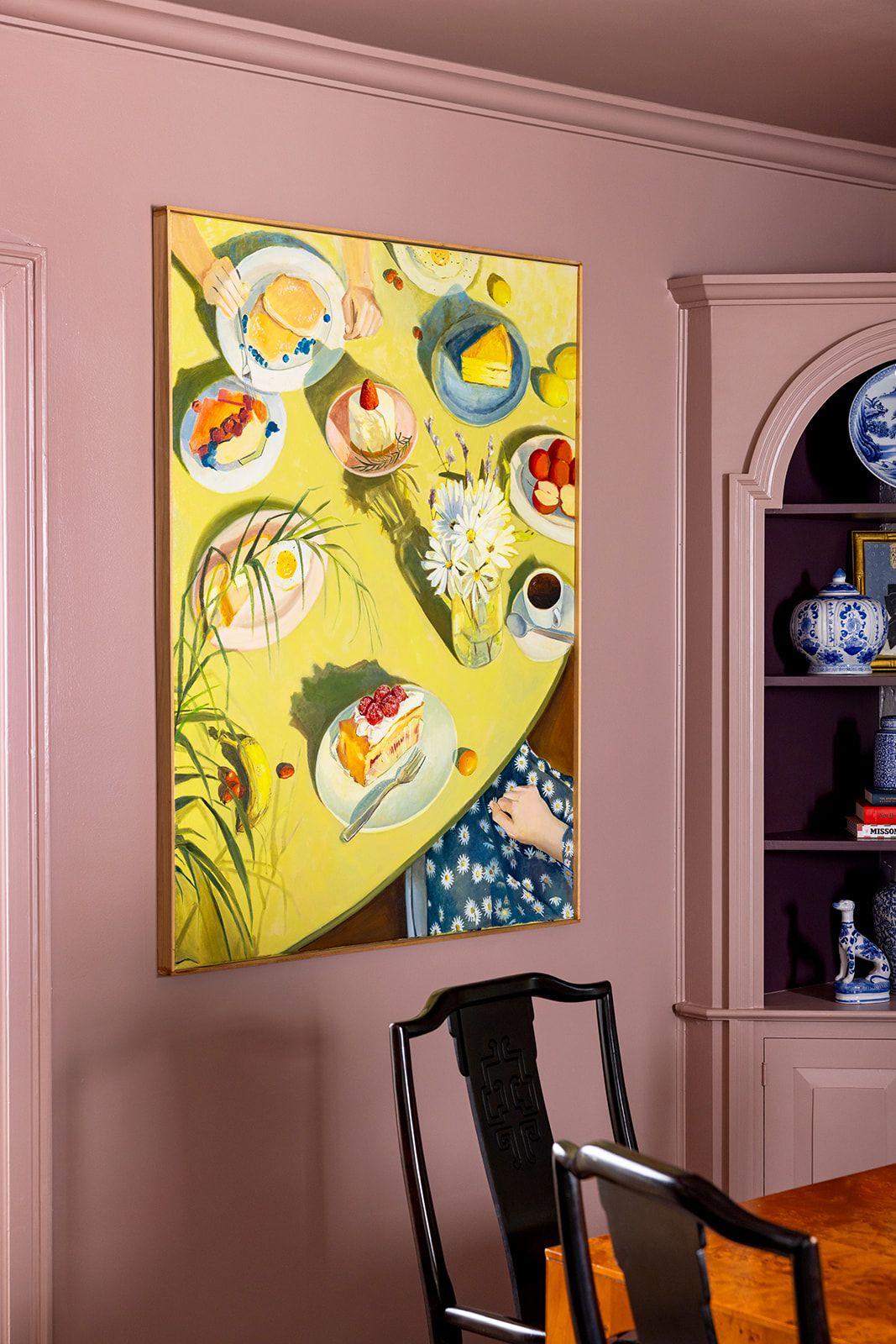 Mauve painted wall featuring a large piece of art