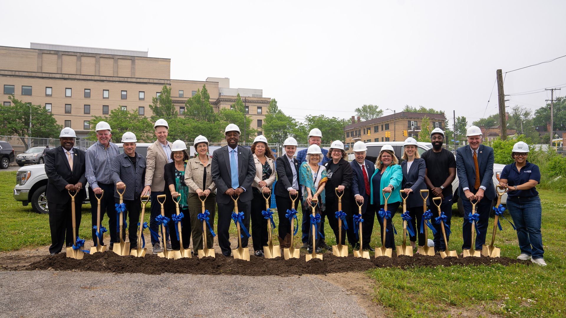 Lineup of people breaking ground