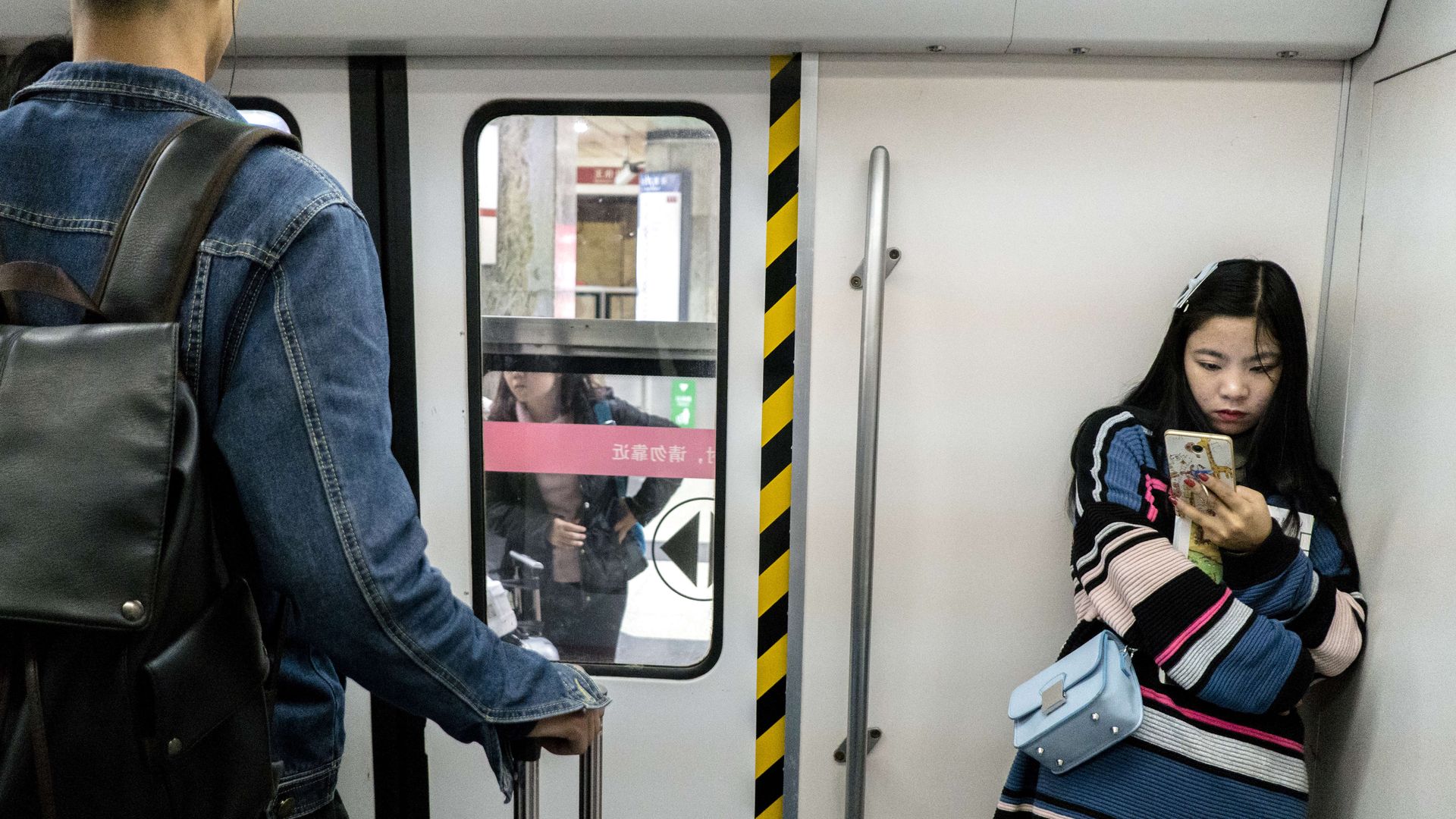 People on smart phones on the subway.