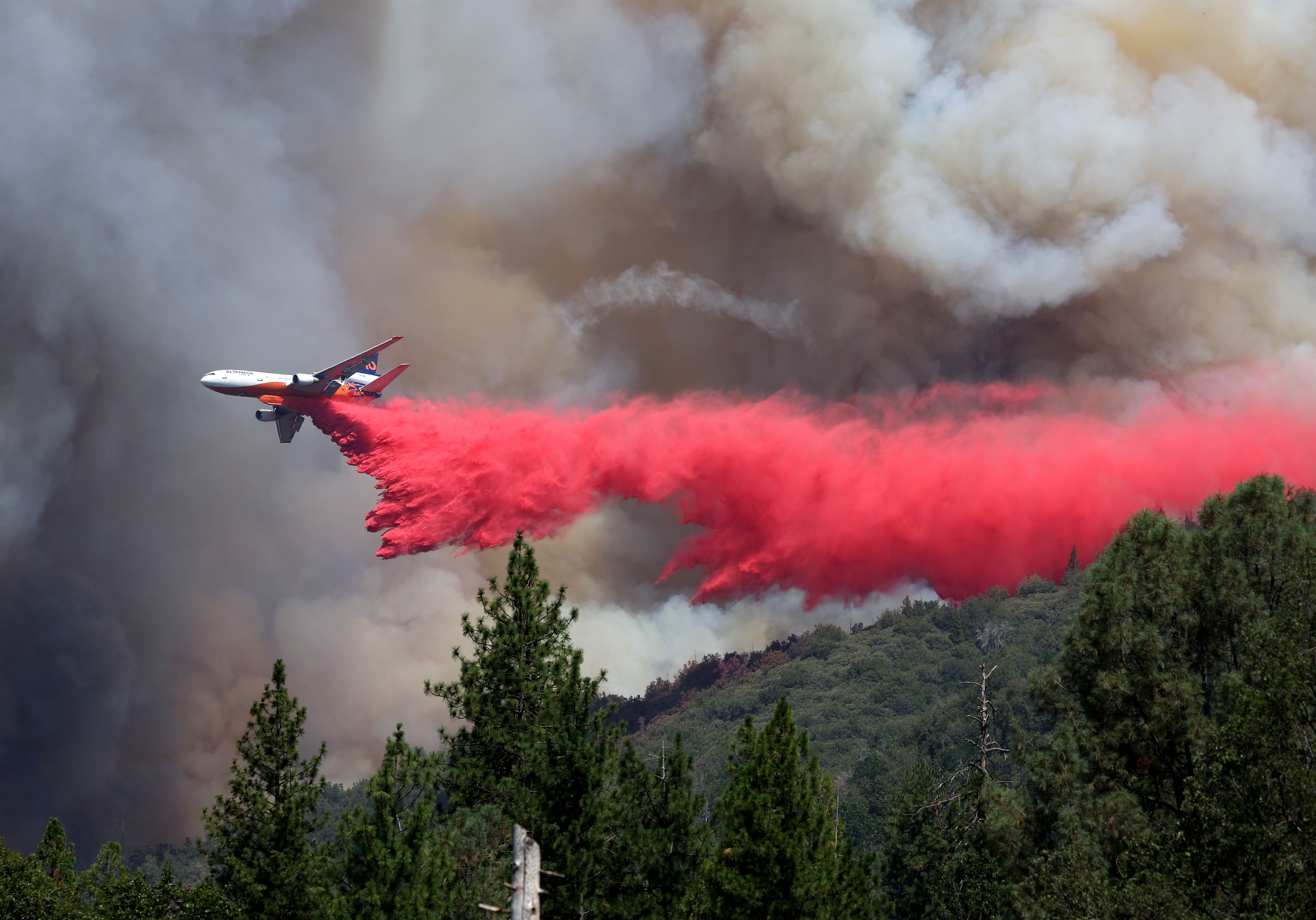 A firefighting aircraft drops retardant ahead of the Oak Fire on July 24, 2022 near Jerseydale, California. 